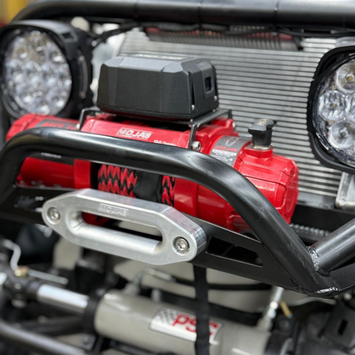 MOJAB OFFROAD MOJAB MO10.0 R-Series 10,000 lb off-road winch with steel cable and rugged metal housing.