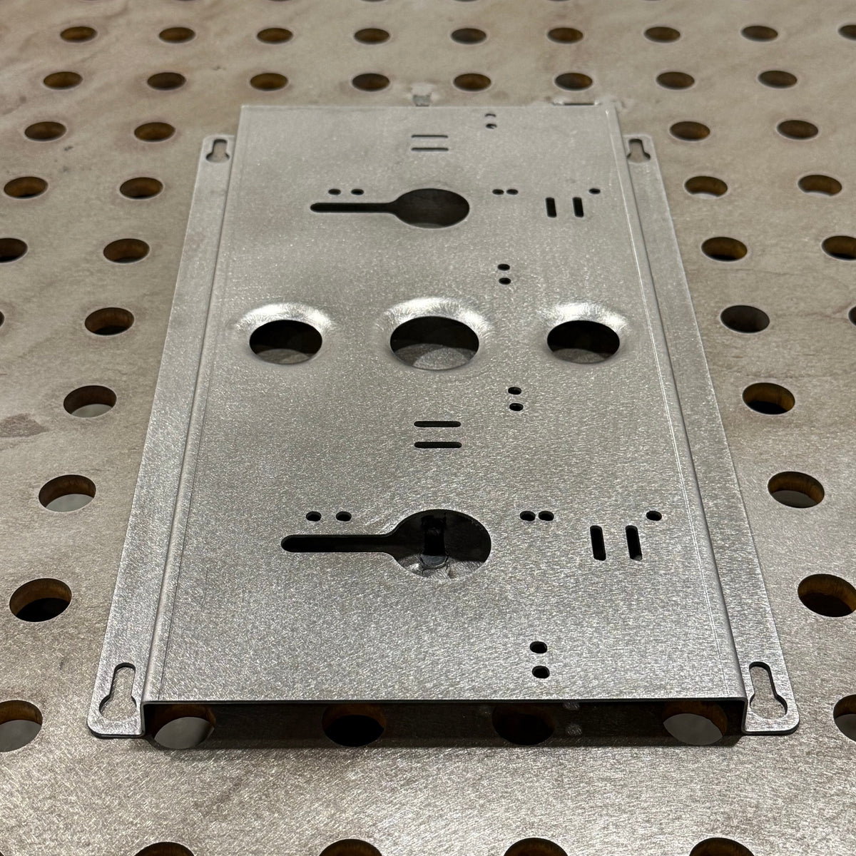 Elevate Metalcraft double charger wall mount plate with ridged design for Milwaukee and DeWalt tools, suitable for vans, trucks, or shop use.
