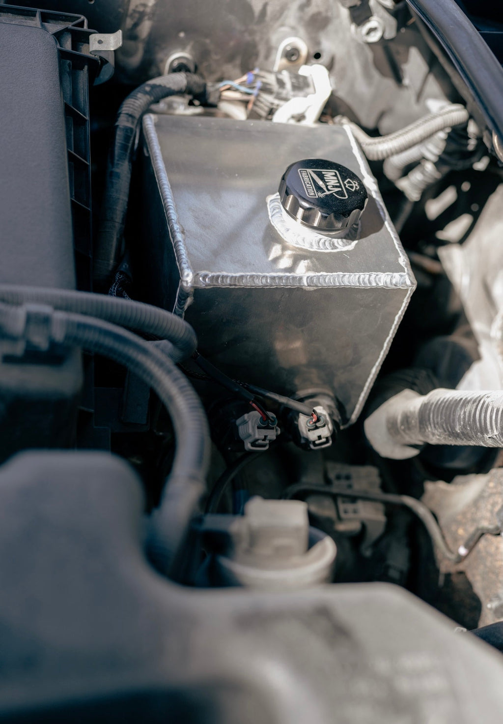 Aluminum washer fluid relocation reservoir kit for 5th Gen Toyota 4Runner (2010–2023) by MNJ Fabrication, shown in full view.
