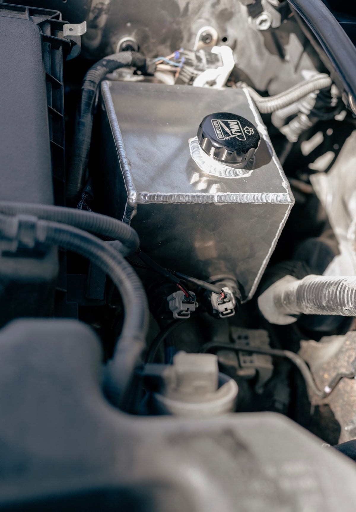 Aluminum washer fluid relocation reservoir kit for 5th Gen Toyota 4Runner (2010–2023) by MNJ Fabrication, shown in full view.