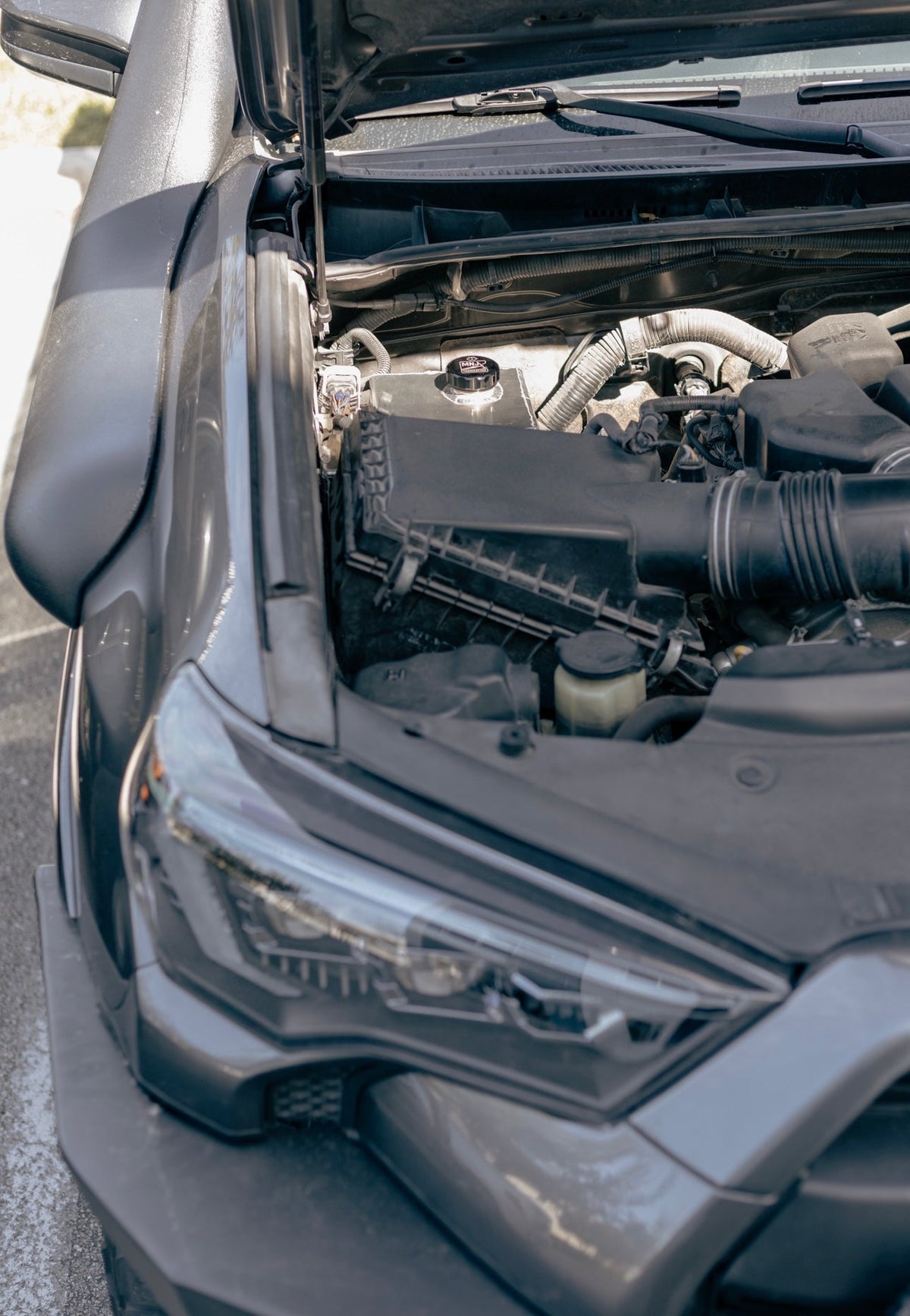 Full view of MNJ Fabrication aluminum washer fluid relocation reservoir kit installed in a 5th Gen Toyota 4Runner (2010–2023).