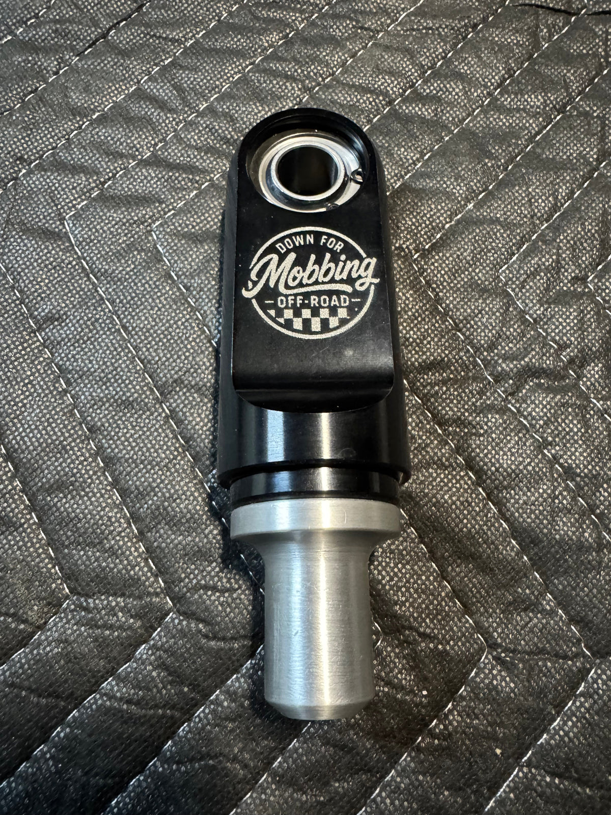 RC Fabrication offroad shock rod end shifter part, showing the metal component with detailed threading and mounting points.