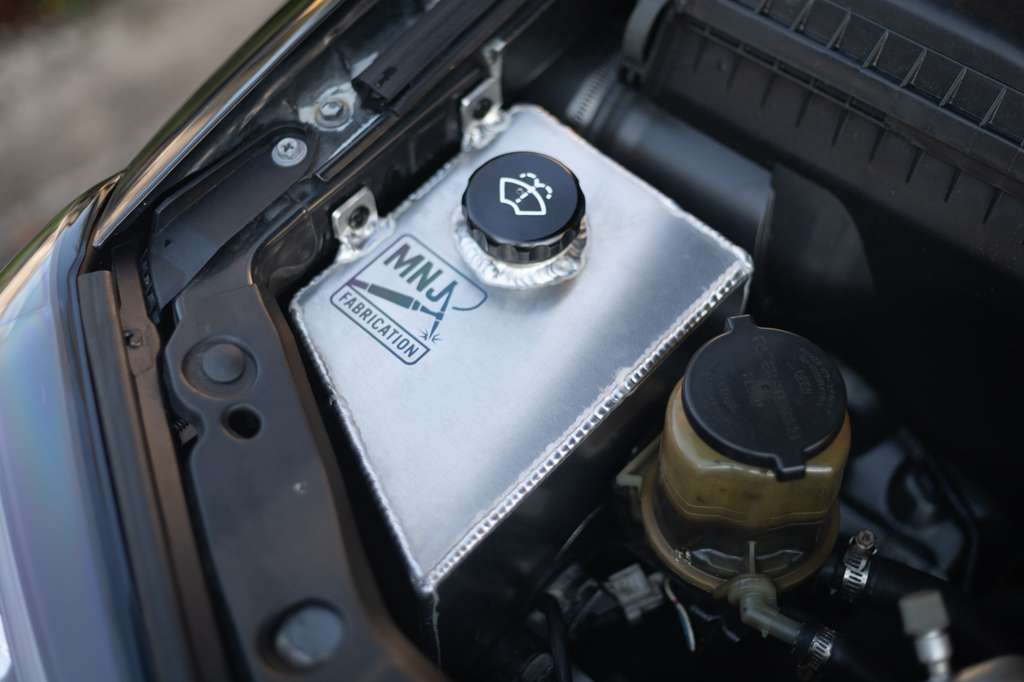 Aluminum washer fluid reservoir kit for 4th Gen Toyota 4Runner (2003–2009) by MNJ Fabrication, shown installed in the engine bay.