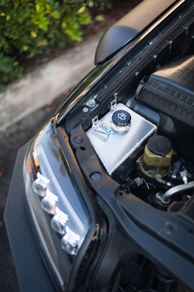 Aluminum washer fluid relocation reservoir kit for 4th gen Toyota 4Runner (2003-2009) by MNJ Fabrication, shown installed.