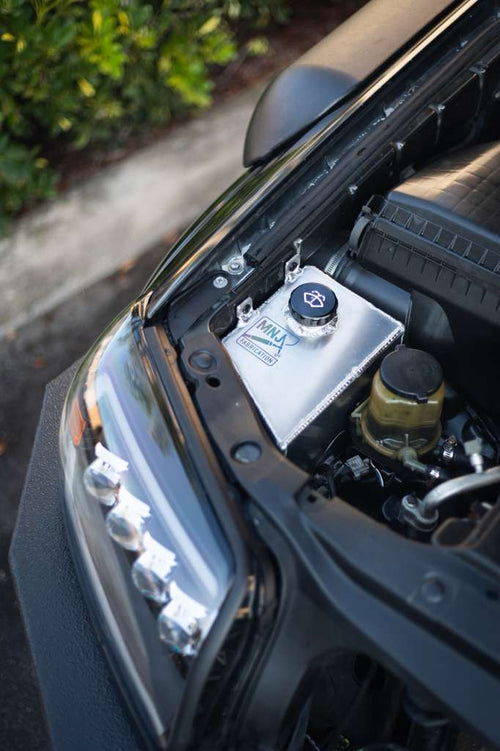 Aluminum washer fluid relocation reservoir kit for 4th gen Toyota 4Runner (2003-2009) by MNJ Fabrication, shown installed.
