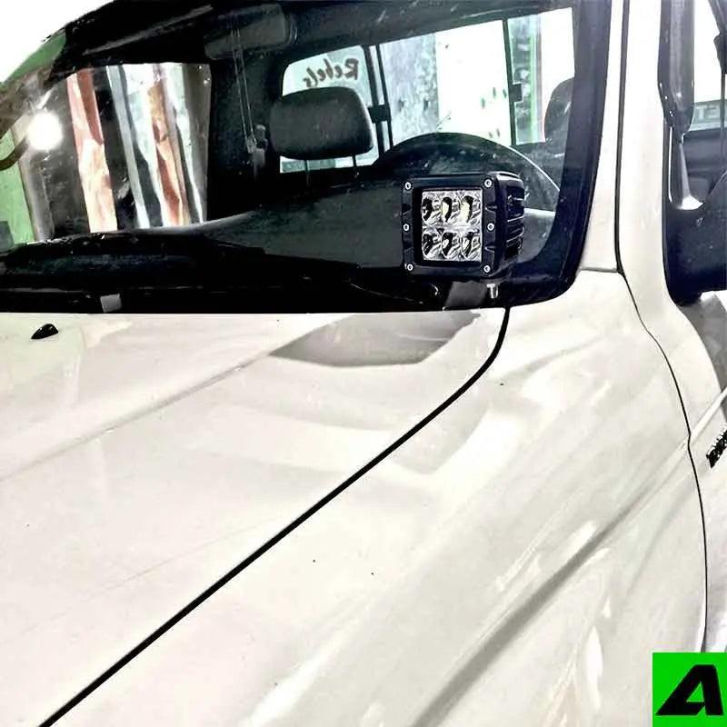 Toyota Tacoma 1995-2004 hood ditch light mounts by Apoc Industries, showing durable metal brackets for off-road lighting.