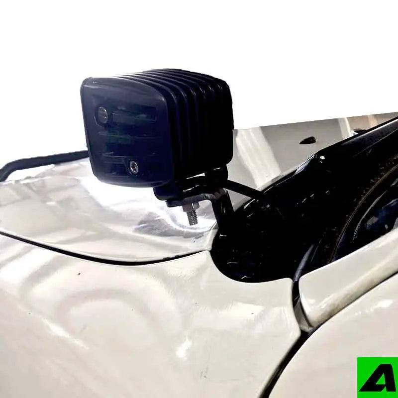 Toyota Tacoma hood ditch light mounts by Apoc Industries, designed for 1995-2004 models, shown attached to the vehicle's hood.
