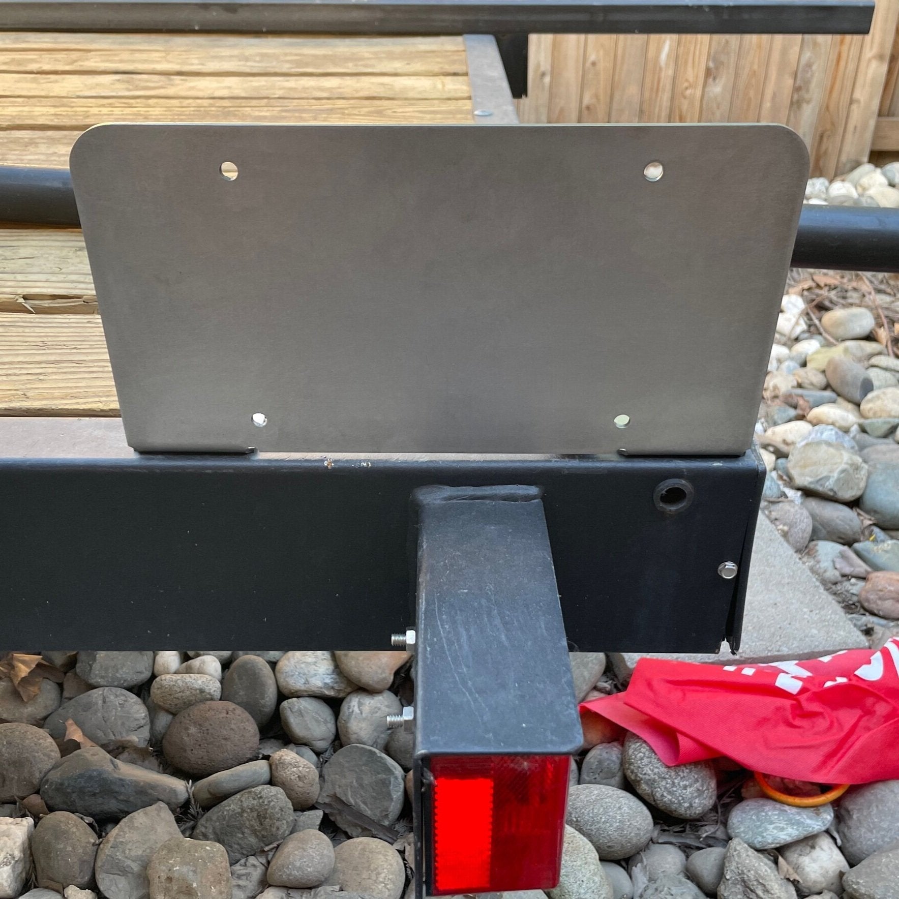 Heavy-duty steel bottom top license plate holder for trailers, RVs, and semi-trailers, designed for bolt-on installation by Elevate Metalcraft.