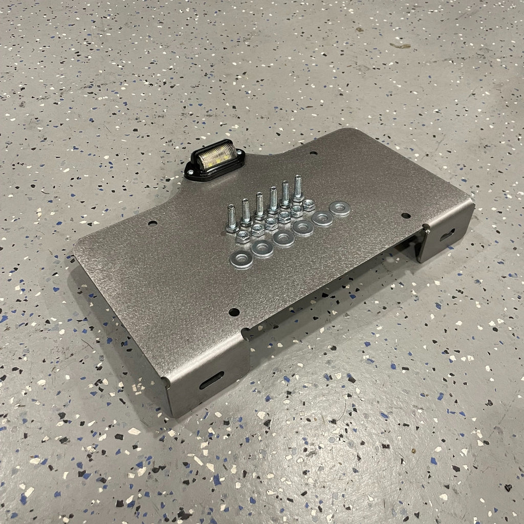 Heavy-duty steel bottom top mount license plate holder for trailers, flatbeds, RVs, and semi-trucks with LED light by Elevate Metalcraft.