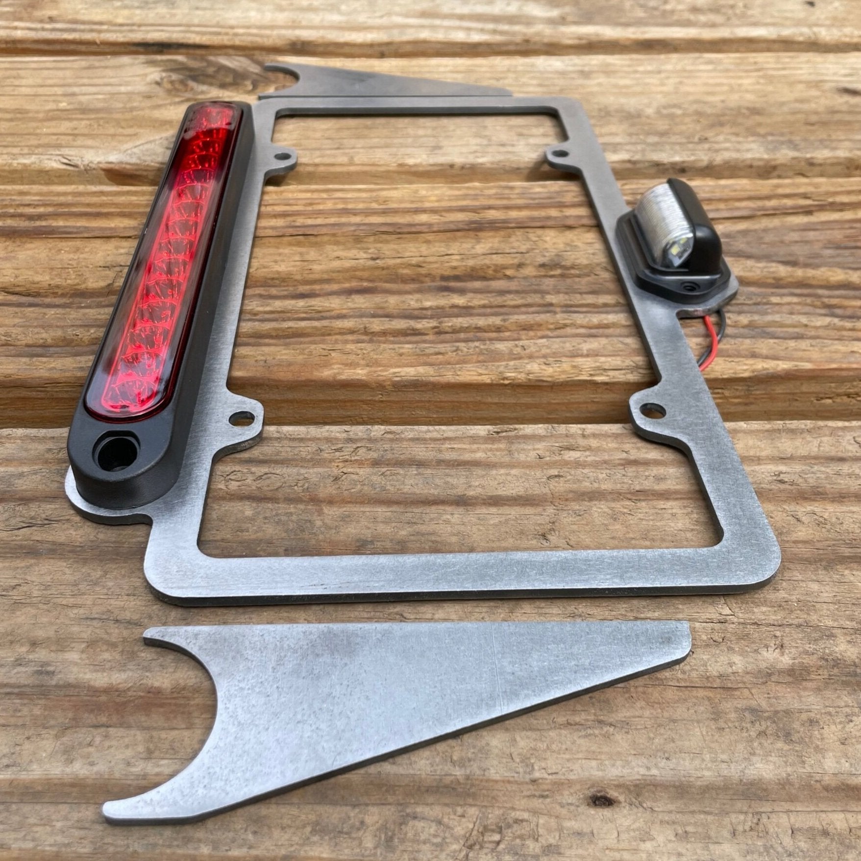 Elevate Metalcraft license plate relocation frame with 3rd brake light weld-on for 1.5 and 1.75-inch tubing, metal construction.