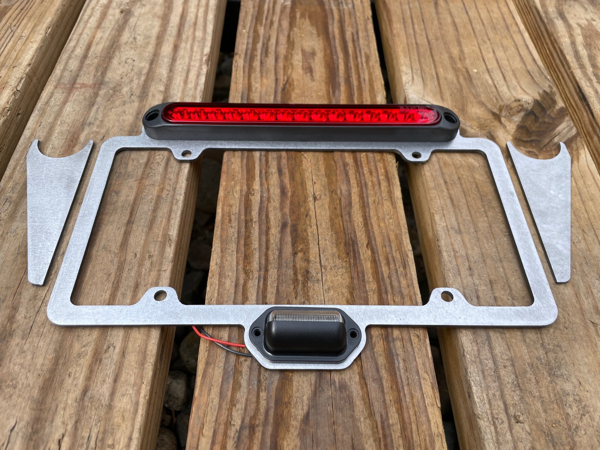 Elevate Metalcraft license plate relocation frame with 3rd brake light weld-on for tubing 1.5 and 1.75 inches, durable metal construction.