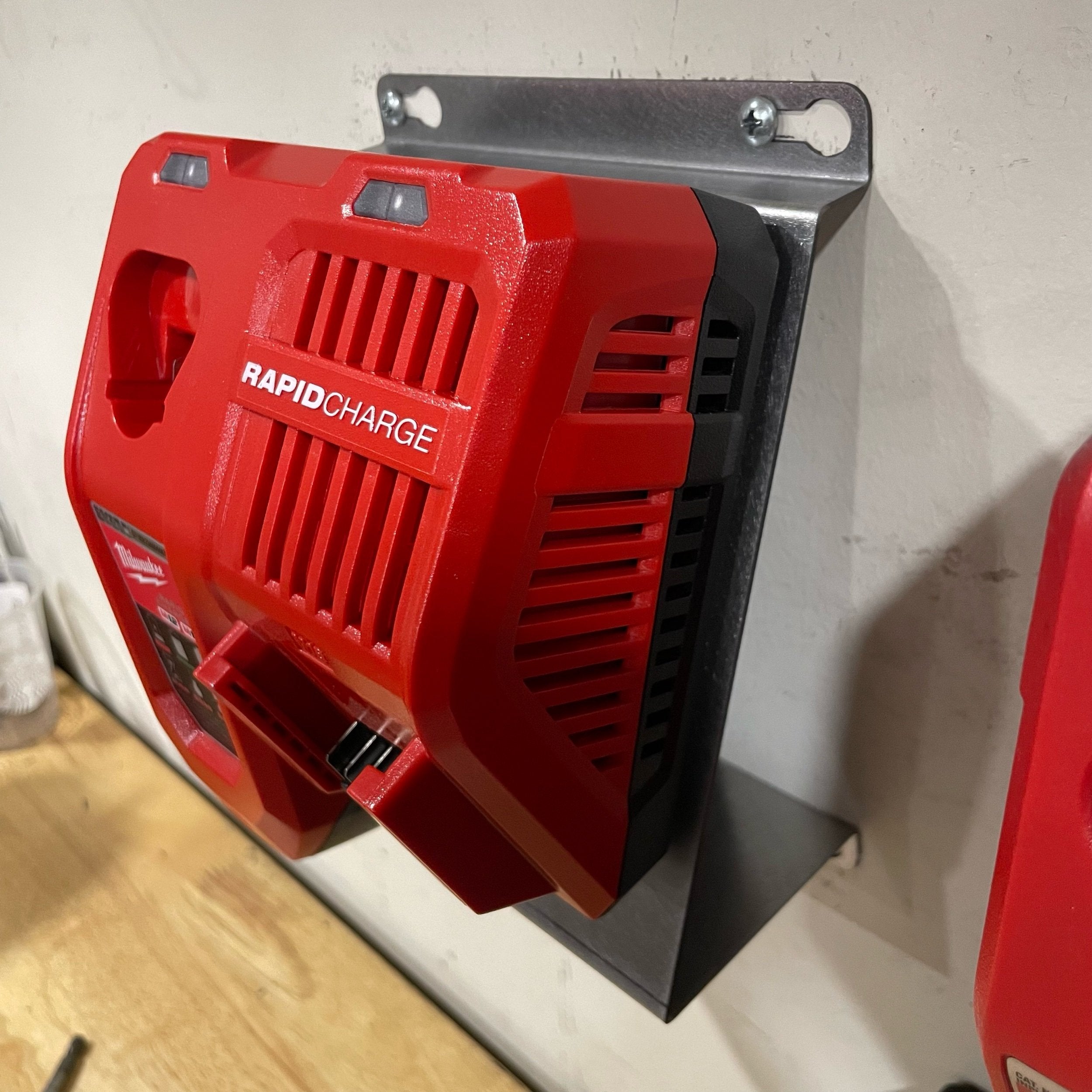 Elevate Metalcraft Milwaukee M18 M12 rapid battery charger wall mount plate at 20-degree angle for van, truck, or workshop use.