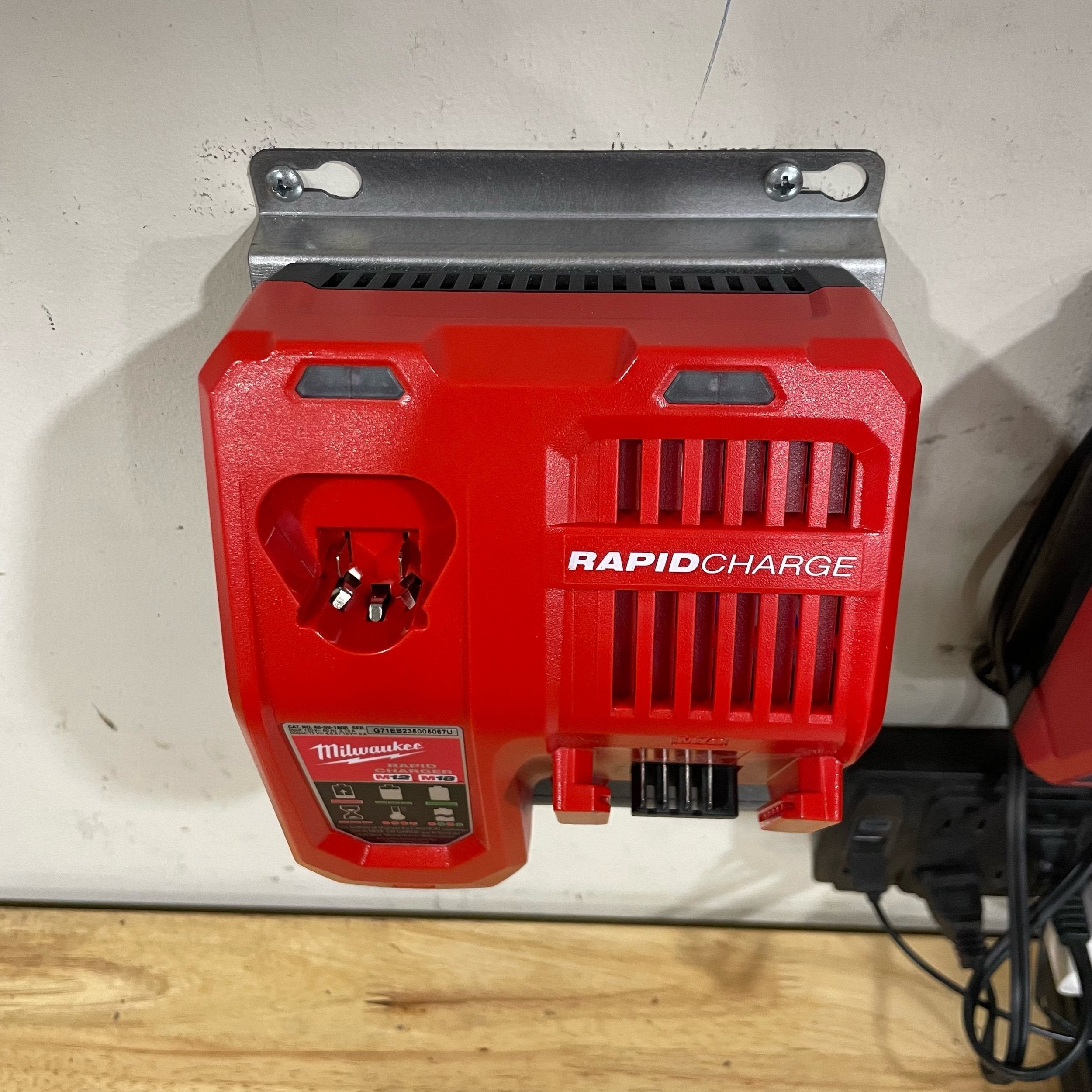 Elevate Metalcraft Milwaukee M18 M12 rapid battery charger wall mount plate at 20-degree angle for van, truck, or shop use.