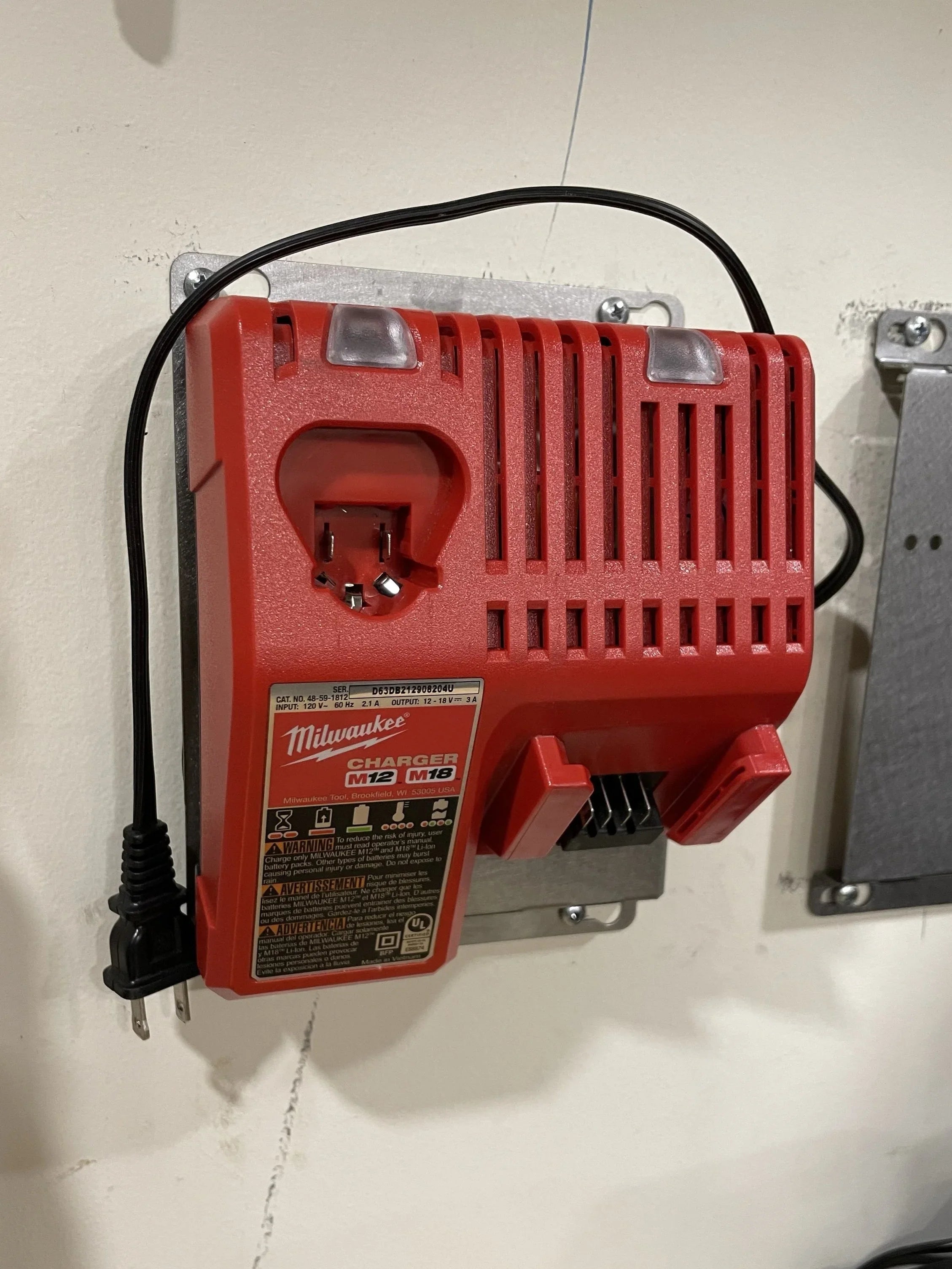 Elevate Metalcraft wall mount plate for Milwaukee and DeWalt chargers, ridged design for van, truck, or shop organization.
