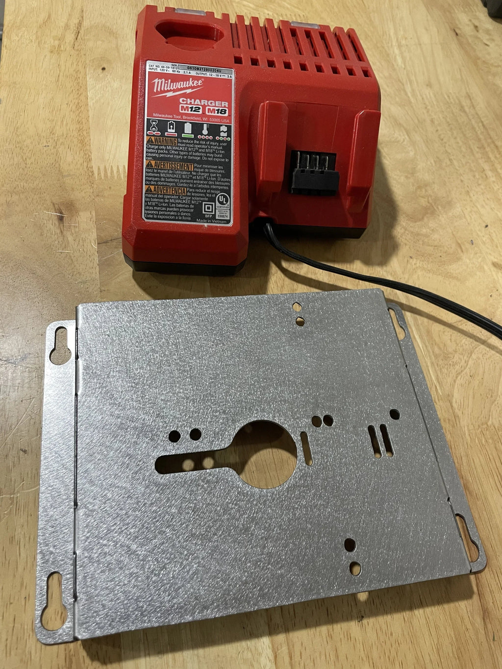 Elevate Metalcraft wall mount plate for chargers, compatible with Milwaukee and DeWalt tools, designed for van, truck, or shop storage.