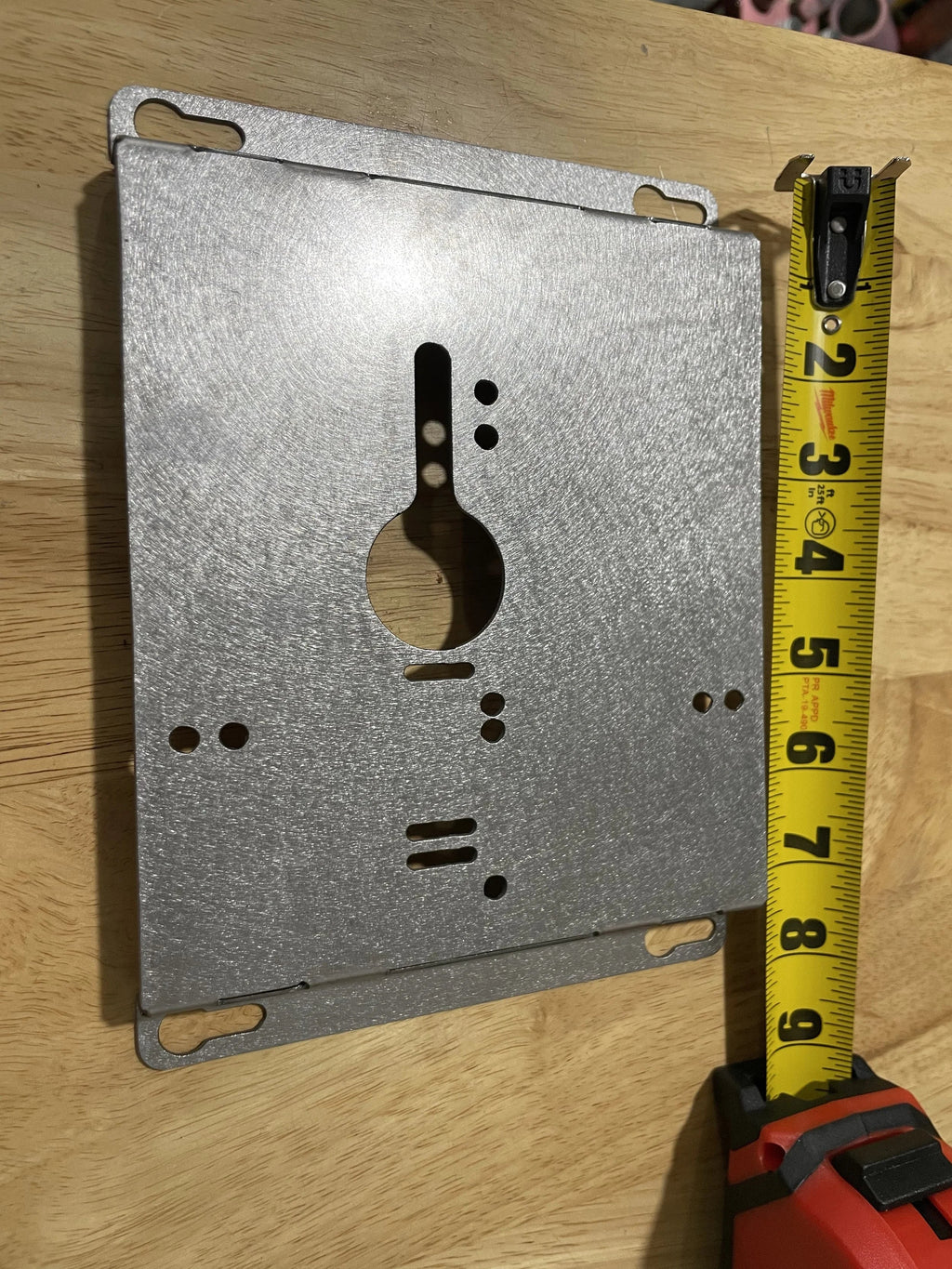 Elevate Metalcraft charger wall mount plate for Milwaukee and DeWalt tools, with ridged design for van, truck, or shop organization.