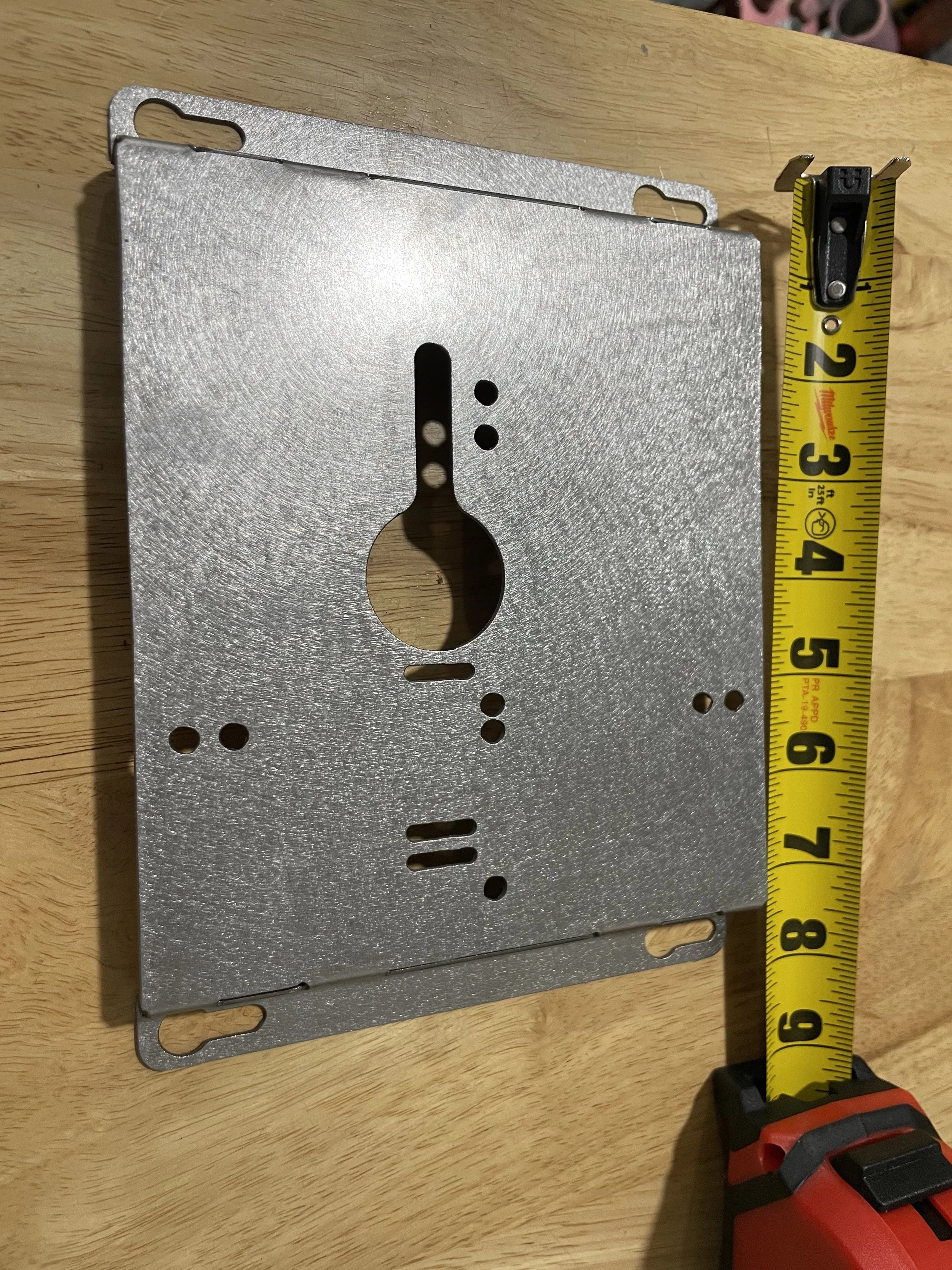 Elevate Metalcraft charger wall mount plate for Milwaukee and DeWalt tools, with ridged design for van, truck, or shop organization.