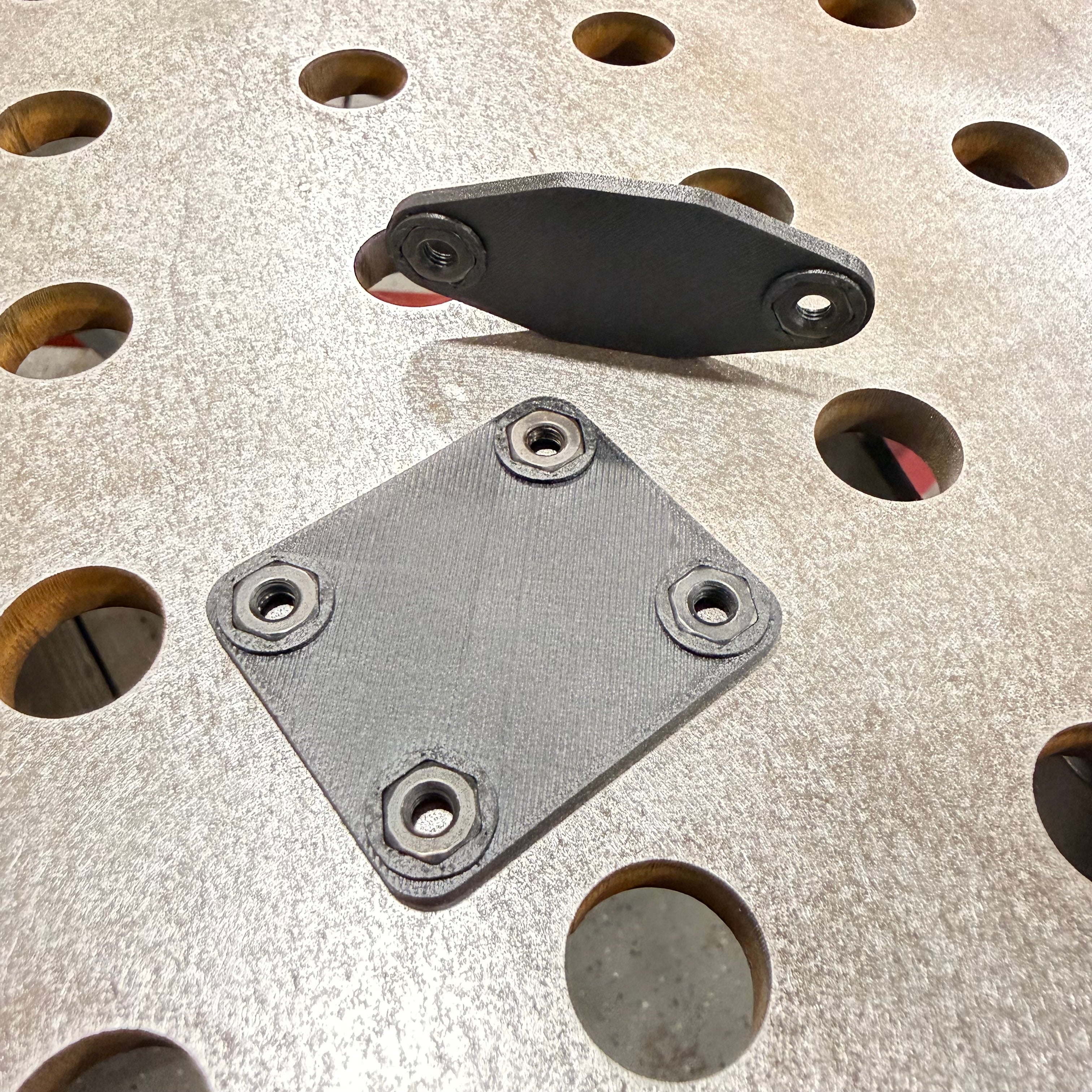 Elevate Metalcraft AMP Ball Magnetic Nut Plates with diamond-shaped design and two bolts for secure fastening.