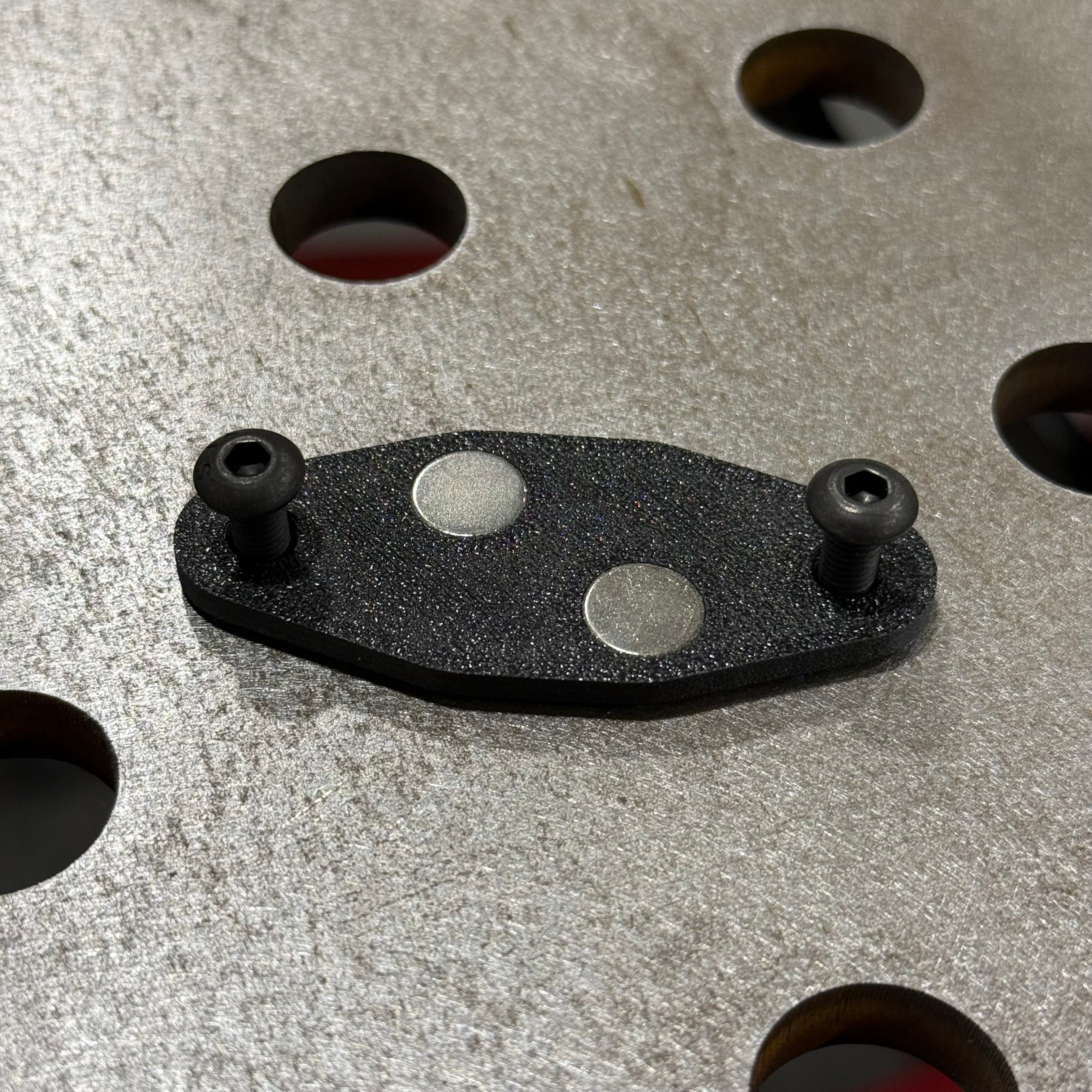 Elevate Metalcraft AMP Ball Magnetic Nut Plates with diamond-shaped design and two bolt holes for secure fastening.
