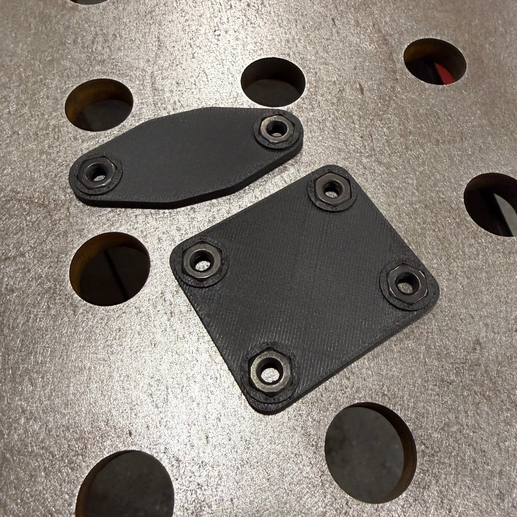 Elevate Metalcraft AMP Ball Magnetic Nut Plates with two bolts, featuring diamond-shaped design and magnetic mounting for secure fastening.