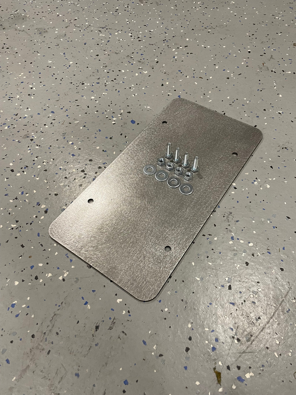 Heavy-duty steel license plate mount by Elevate Metalcraft, bolt-on design for trailers, flatbeds, RVs, and campers.