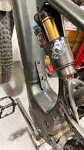 Elevate Metalcraft MTB water bottle cage relocation for Specialized Turbo Levo Gen2, black metal bike accessory, close-up view