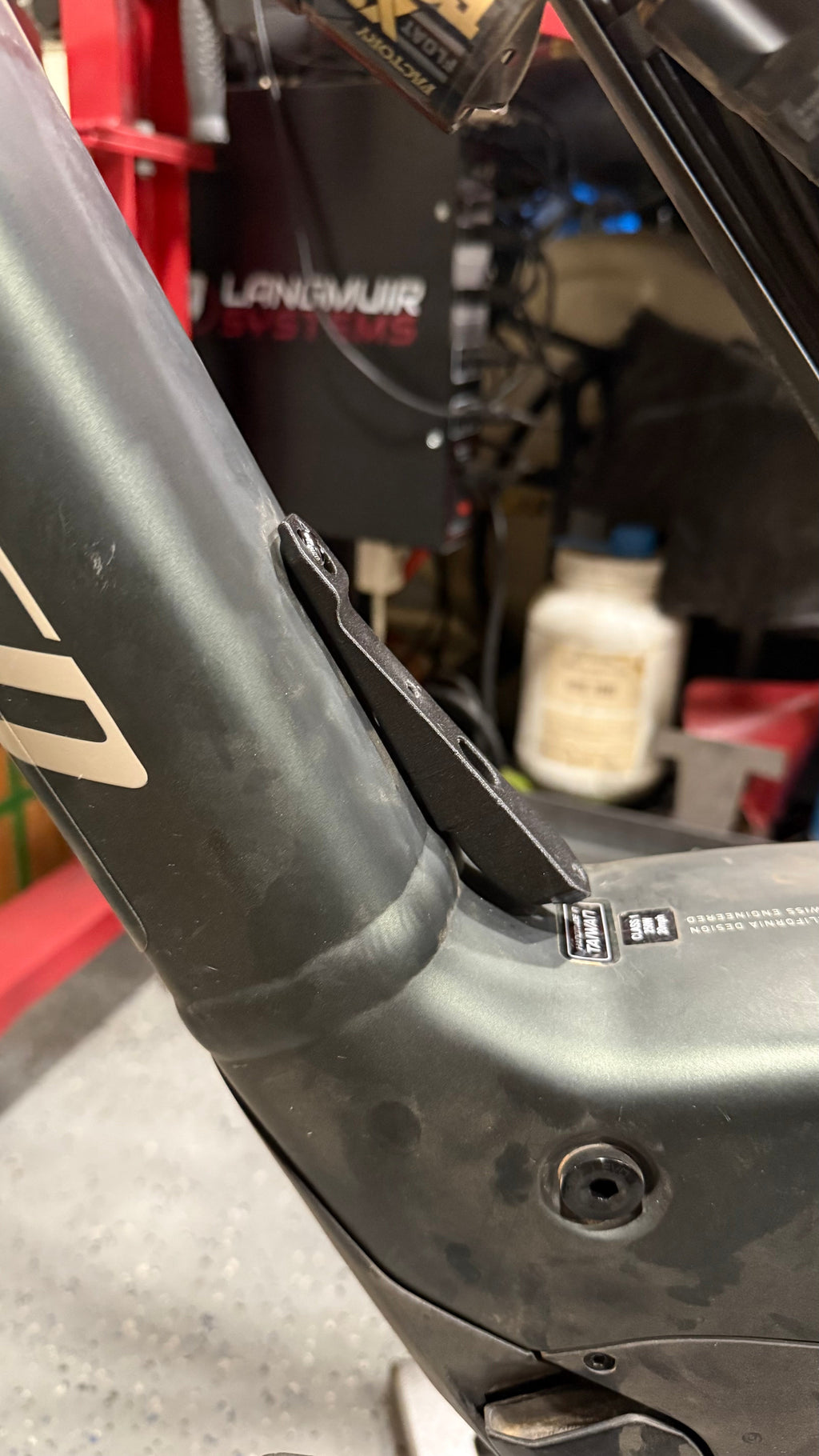 Black MTB water bottle cage relocation by Elevate Metalcraft for Specialized Turbo LEVO Gen2 mountain bike, designed for secure bottle hold.