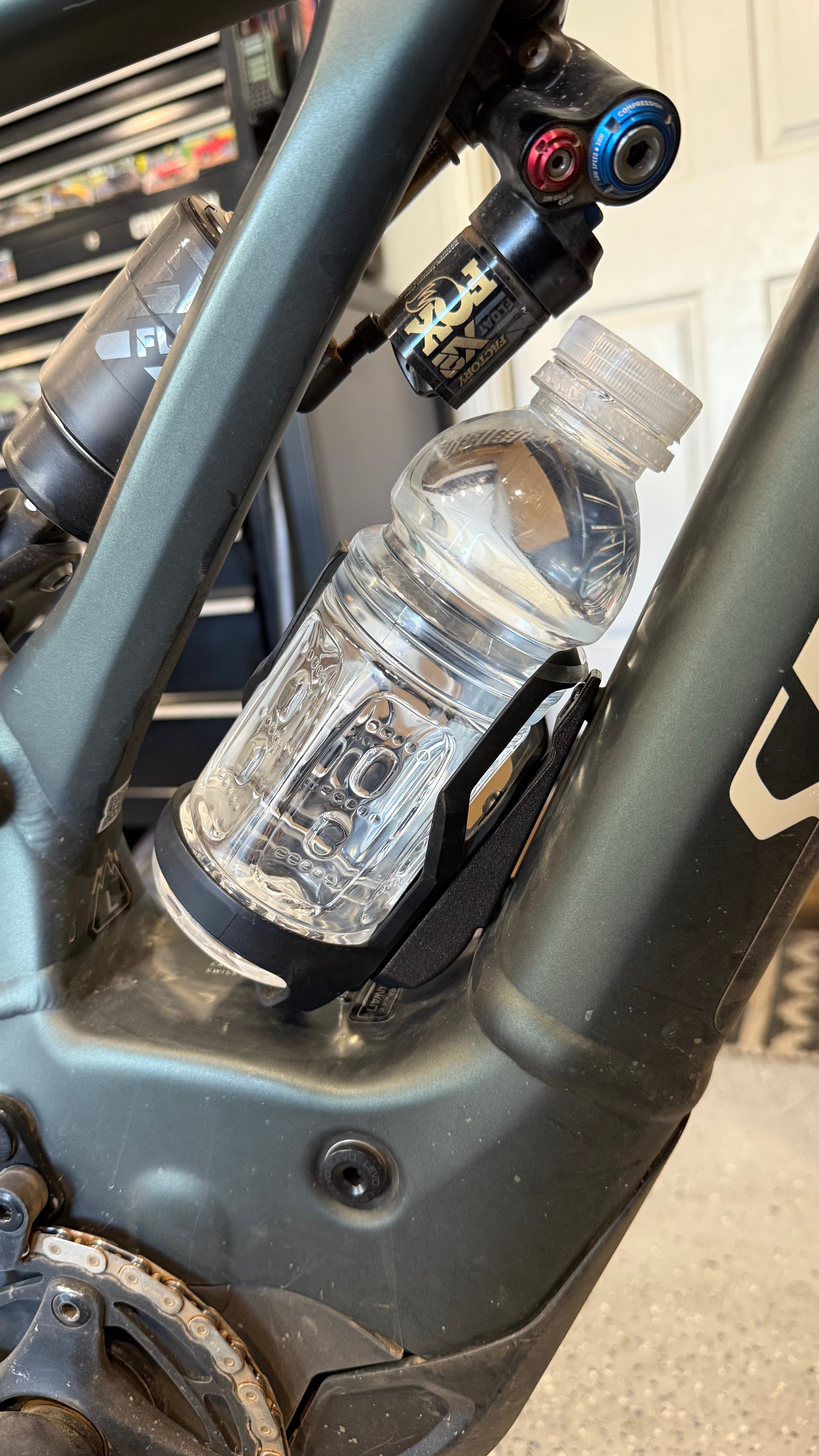Elevate Metalcraft black MTB water bottle cage relocation for Specialized Turbo Levo Gen 2 mountain bike, showing installation details.