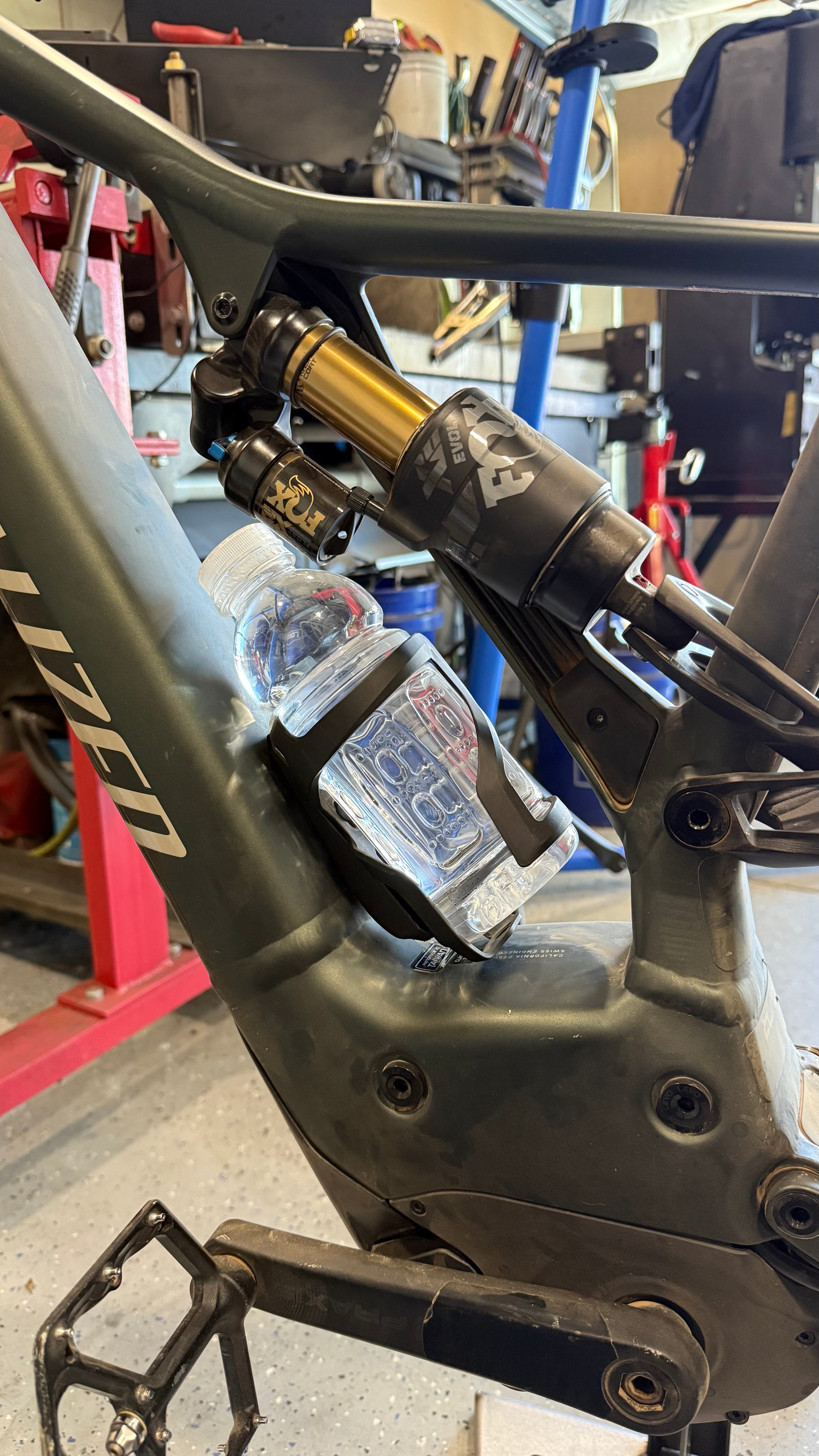 Black MTB water bottle cage relocation for Specialized Turbo Levo Gen2 by Elevate Metalcraft, designed for secure bottle holding.