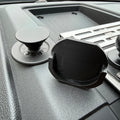Black Elevate Metalcraft Quad Lock Adapter attached to a PopSocket for secure phone mount compatibility.