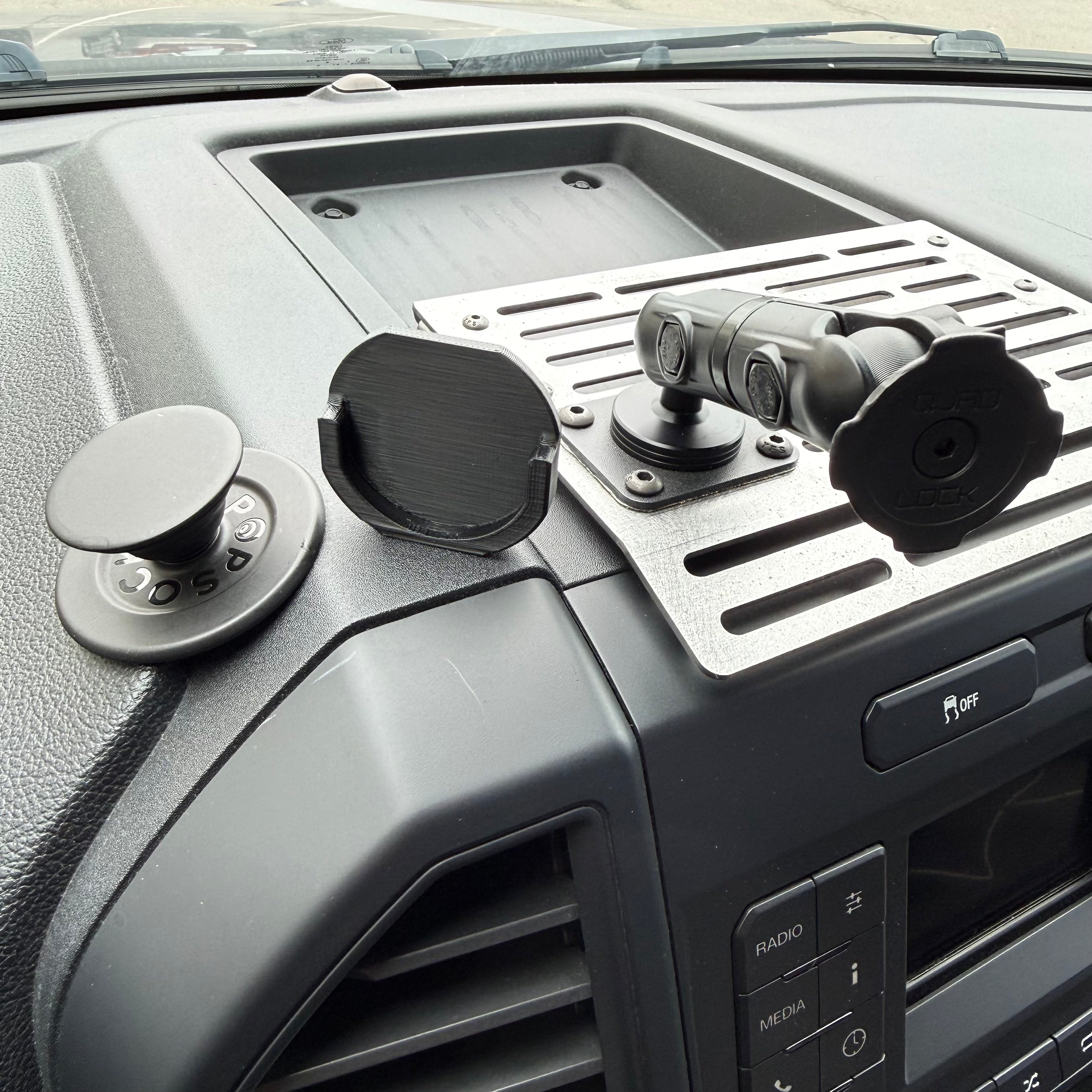 Black Elevate Metalcraft Quad Lock adapter for PopSocket, designed to attach PopSocket to Quad Lock mounts.