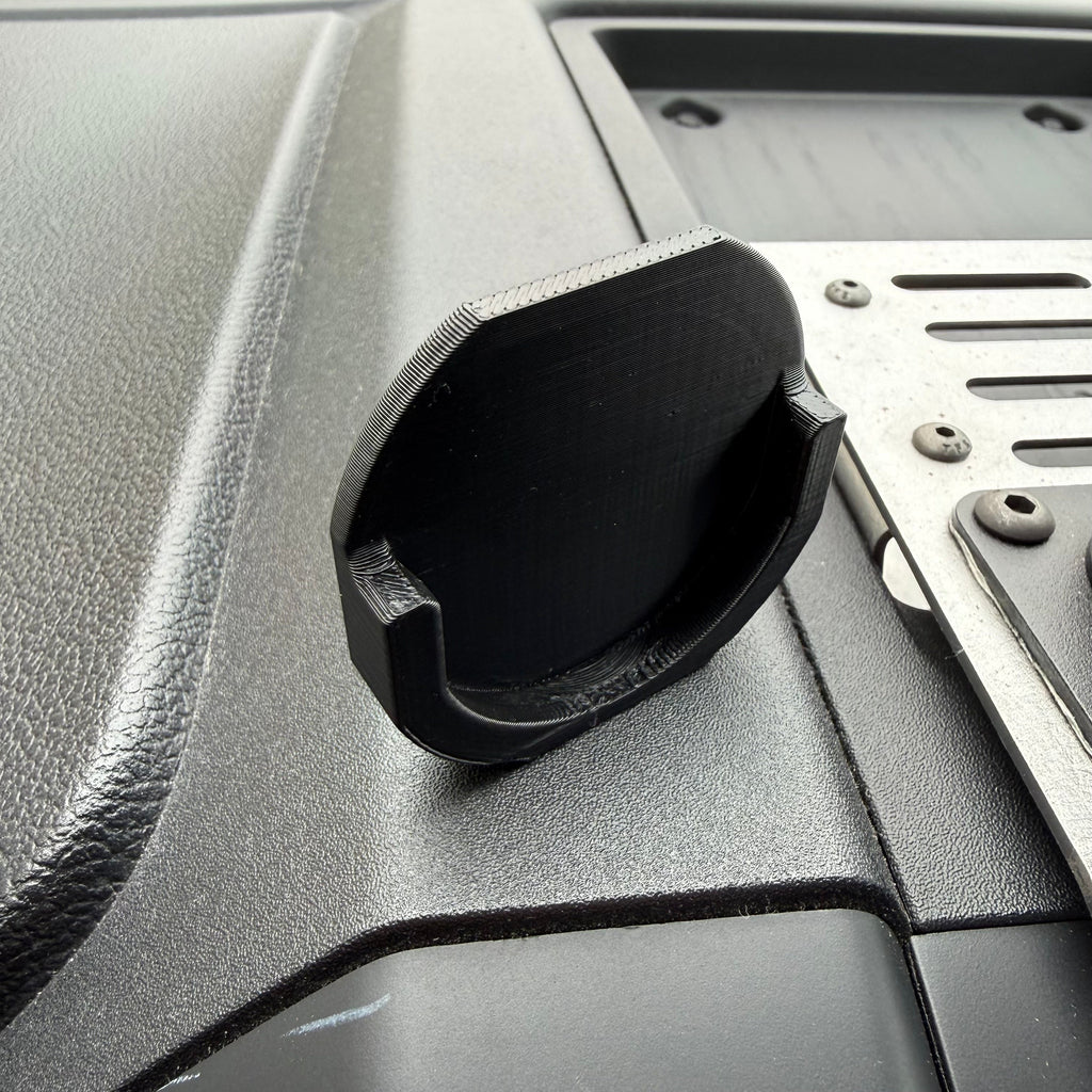 Black Elevate Metalcraft Quad Lock adapter attached to a PopSocket for secure phone mounting.