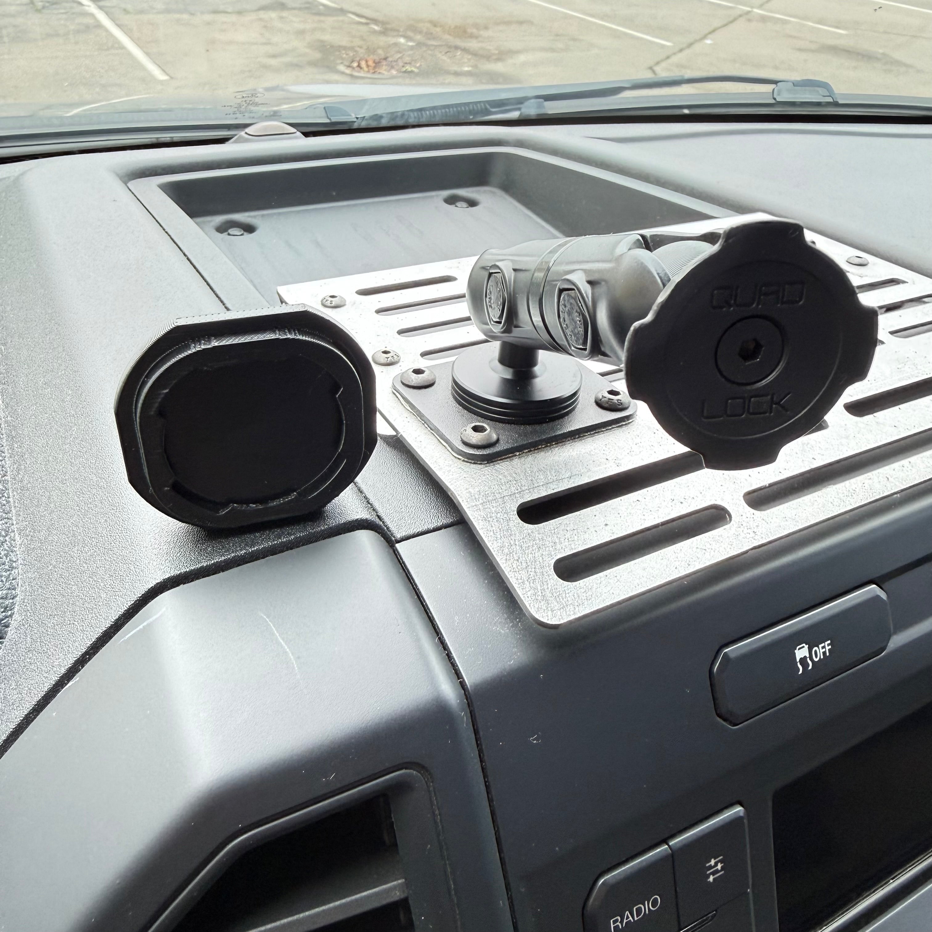 Black Elevate Metalcraft Quad Lock adapter attached to a PopSocket for secure phone mounting.