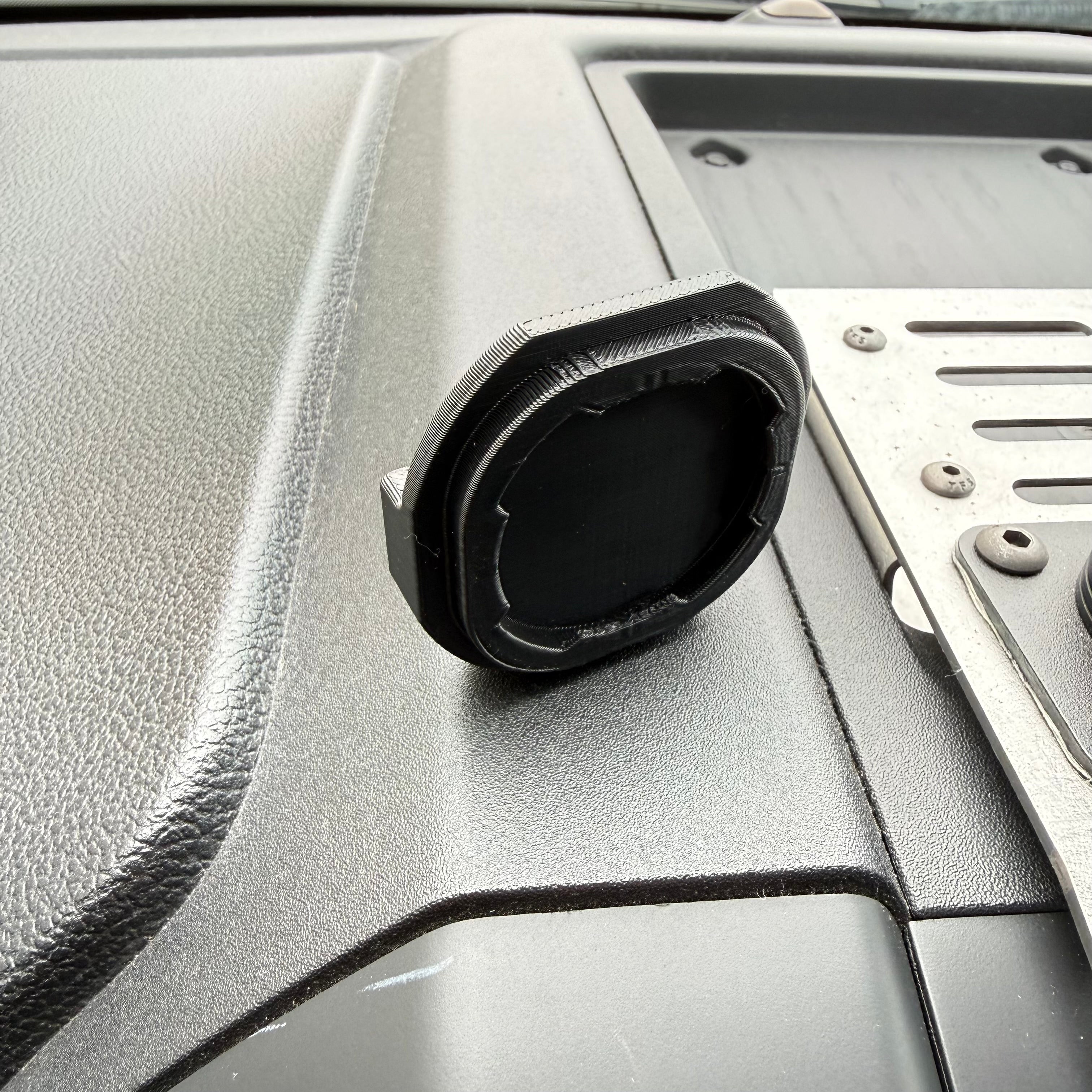 Black Elevate Metalcraft Quad Lock adapter attached to a PopSocket, designed for secure phone mounting and accessory compatibility.