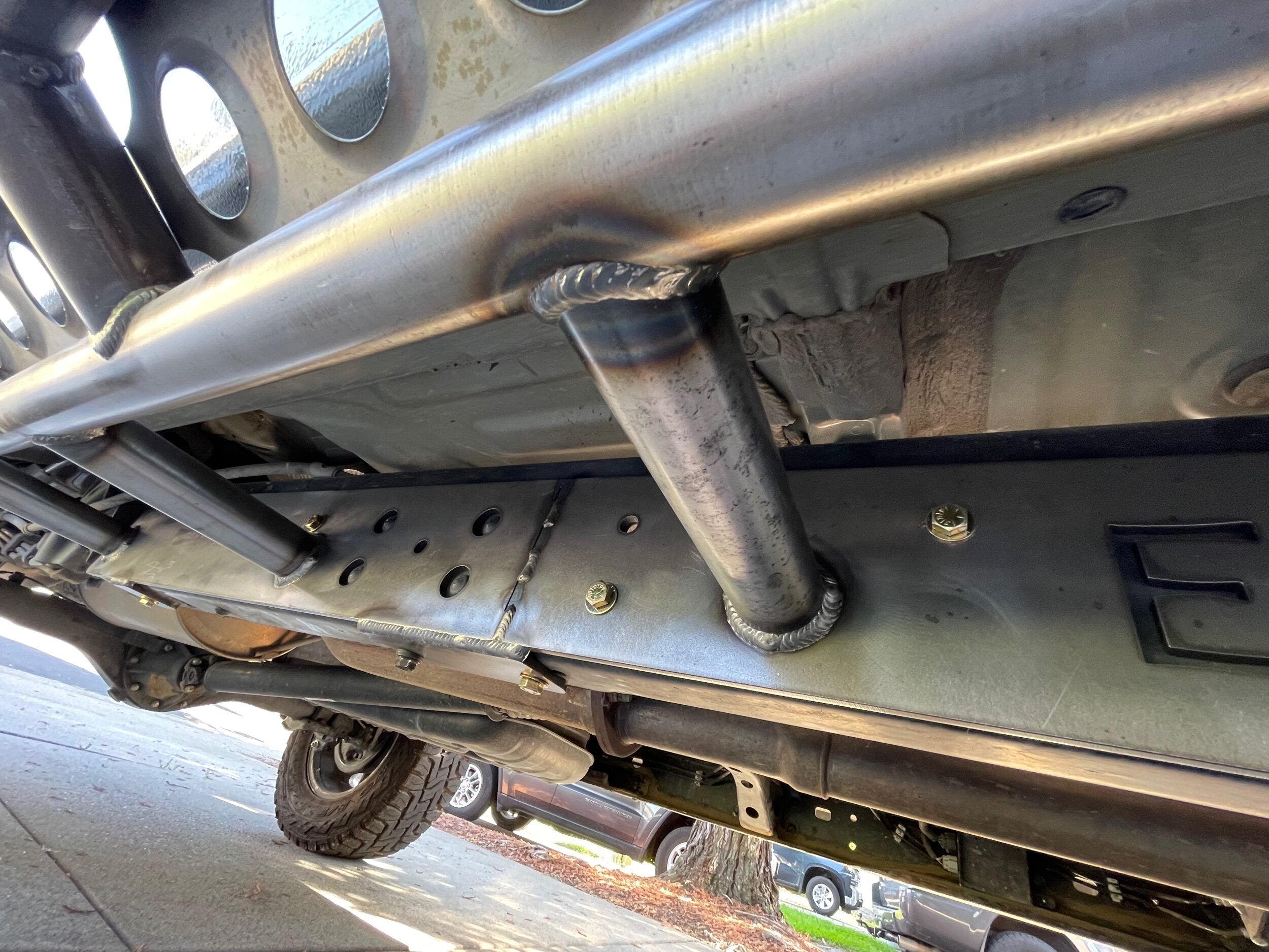 Toyota Tacoma longbed 2016-2023 bolt-on rock slider frame plate kit by Elevate Metalcraft, shown installed on vehicle frame.