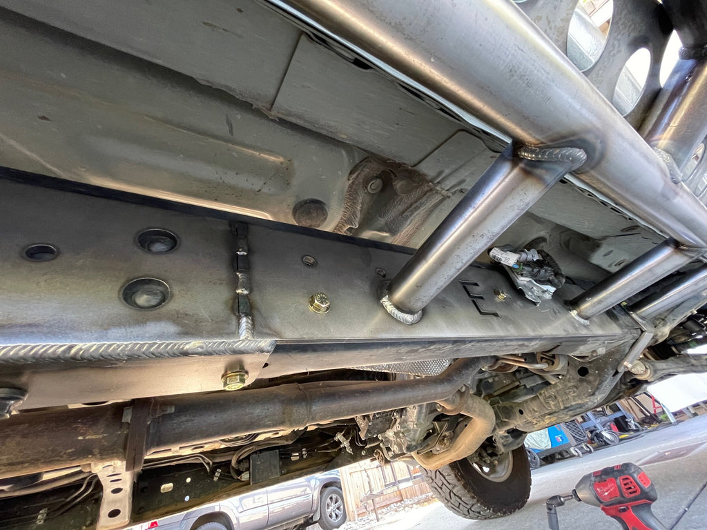 Elevate Metalcraft bolt-on rock sliders frame plate kit installed on a Toyota Tacoma longbed (2016-2023) for off-road protection.