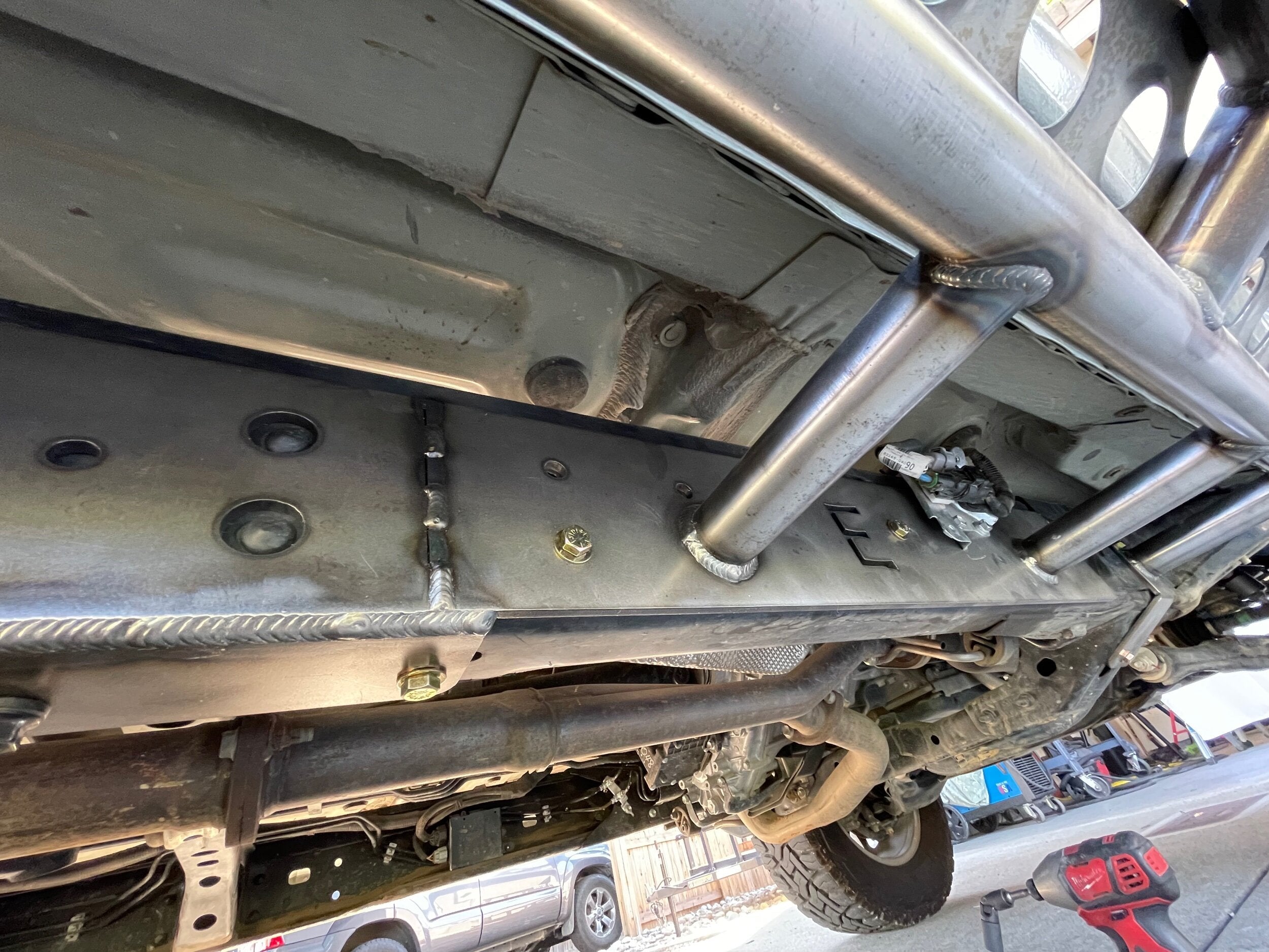 Elevate Metalcraft bolt-on rock sliders frame plate kit installed on a Toyota Tacoma longbed (2016-2023) for off-road protection.