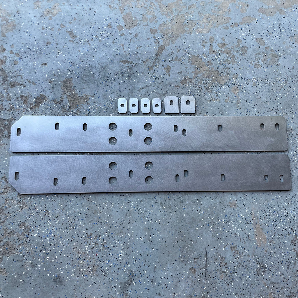 Elevate Metalcraft bolt-on rock sliders and frame plate kit installed on a Toyota Tacoma Shortbed (16-23) for off-road protection.