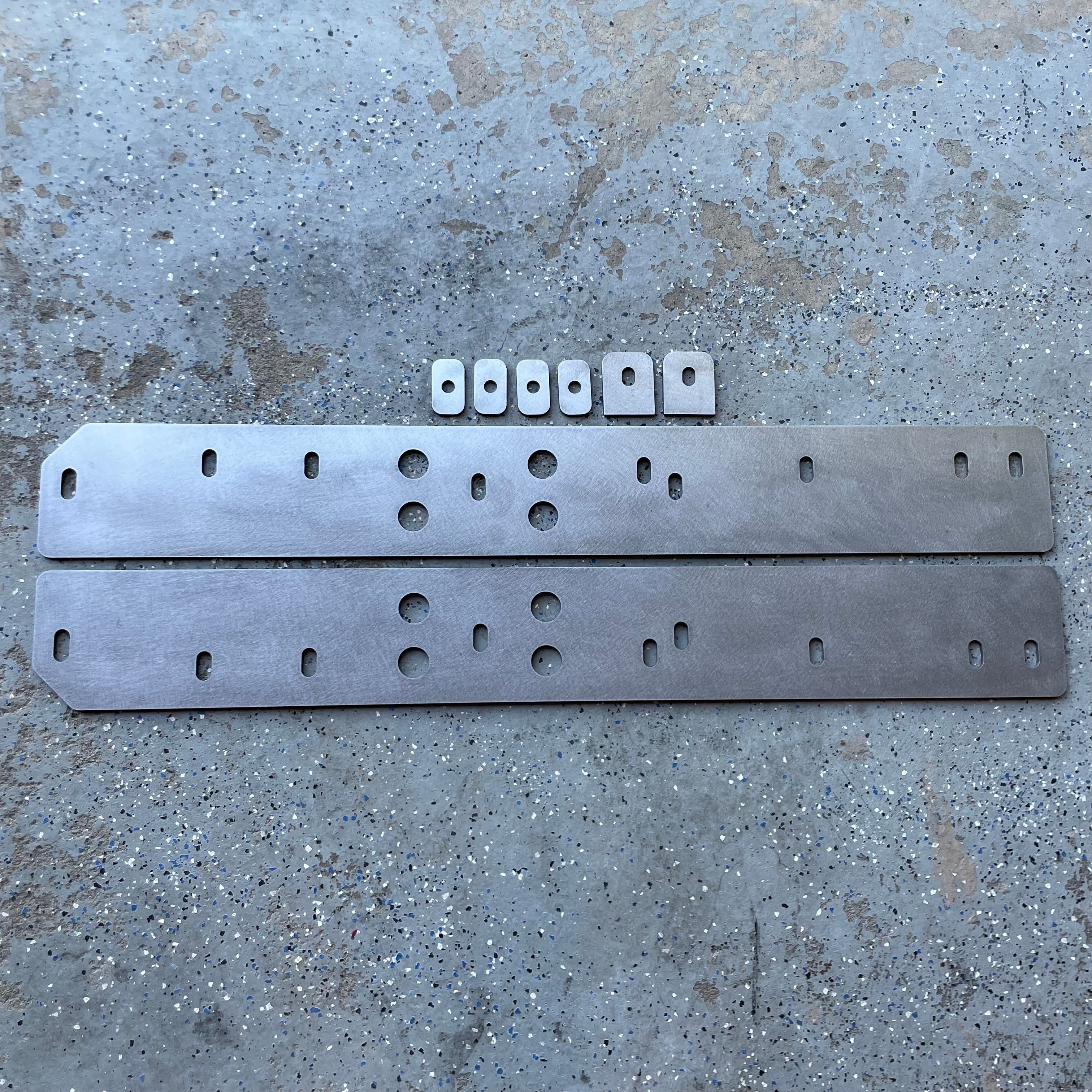 Elevate Metalcraft bolt-on rock sliders and frame plate kit installed on a Toyota Tacoma Shortbed (16-23) for off-road protection.