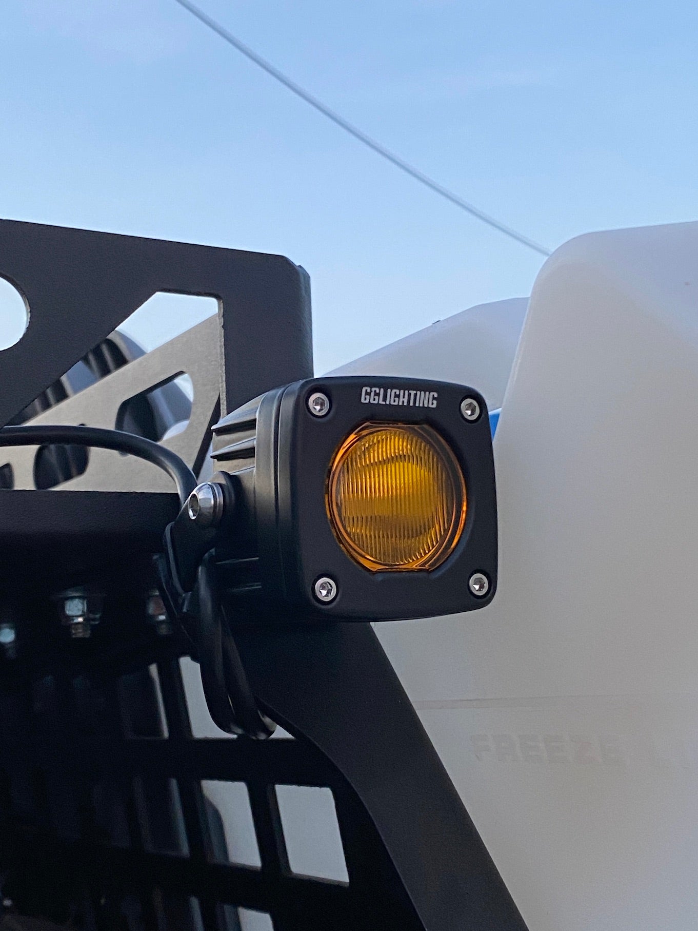 GGLighting GP5 single LED pod light in amber with clear lens, showing the compact, durable automotive lighting fixture.