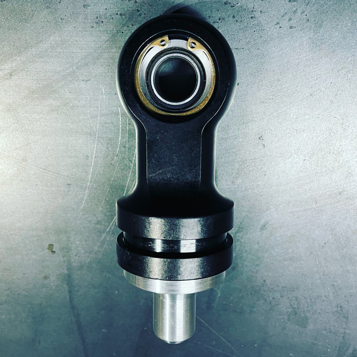 RC Fabrication offroad shock rod end shifter part showing metal rod end with mounting hardware for vehicle suspension.