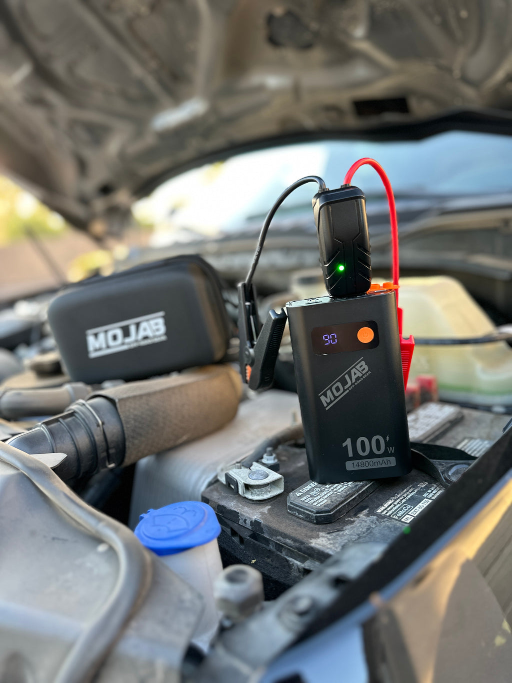 MOJAB OFFROAD battery booster and jump starter device with portable design and safety features for vehicle emergency use.