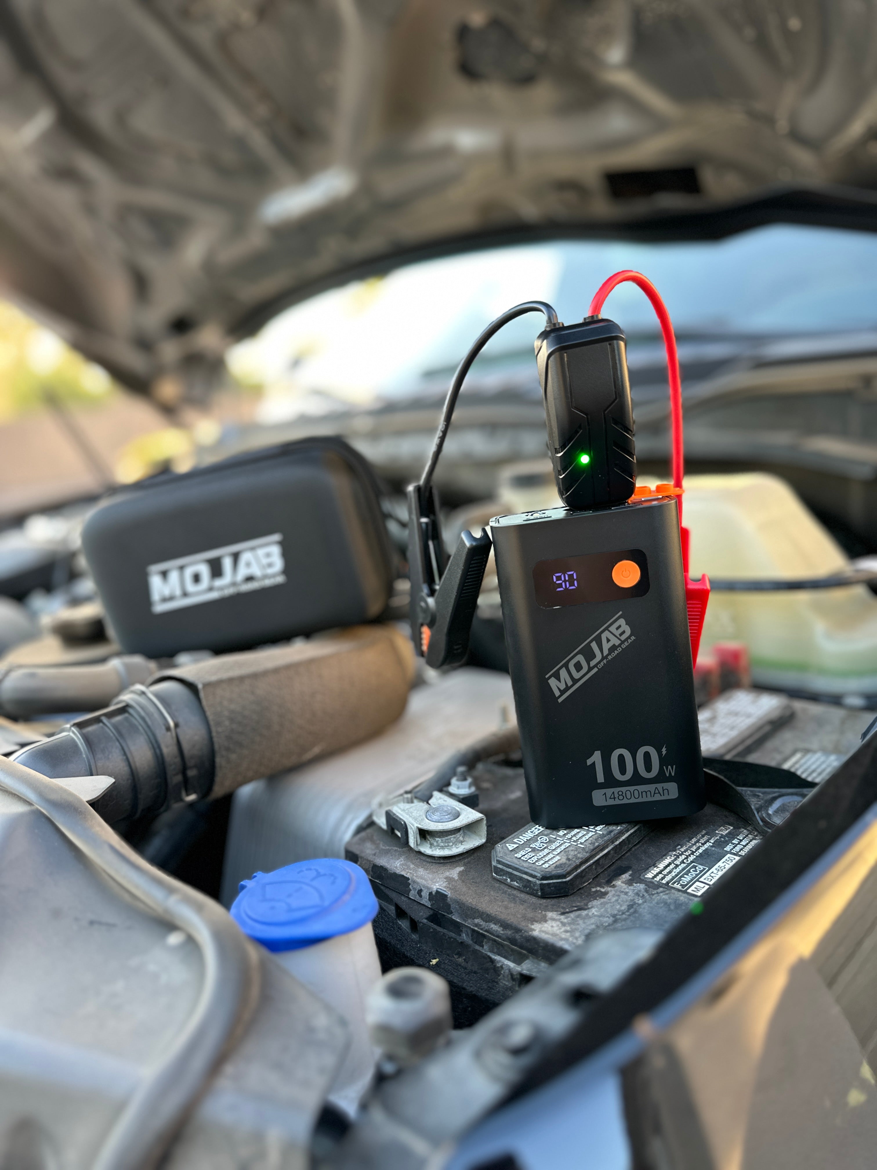 MOJAB OFFROAD battery booster and jump starter device with portable design and safety features for vehicle emergency use.