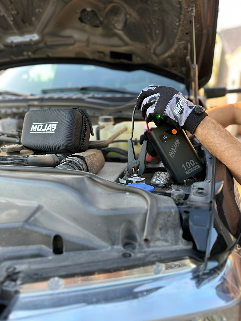 MOJAB OFFROAD battery booster and jump starter with compact design and portable handle, ideal for vehicle emergency power.
