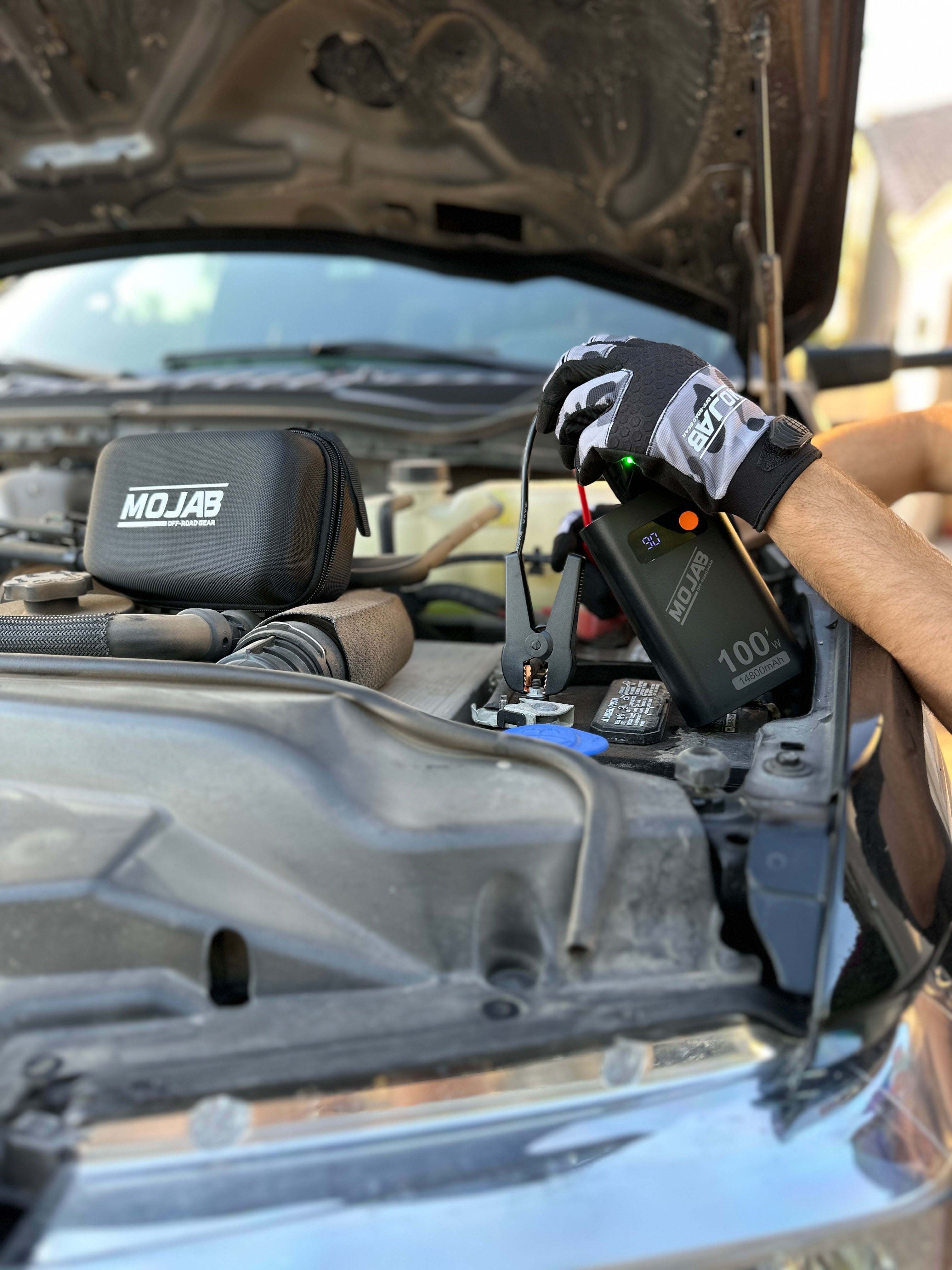 MOJAB OFFROAD battery booster and jump starter with compact design and portable handle, ideal for vehicle emergency power.