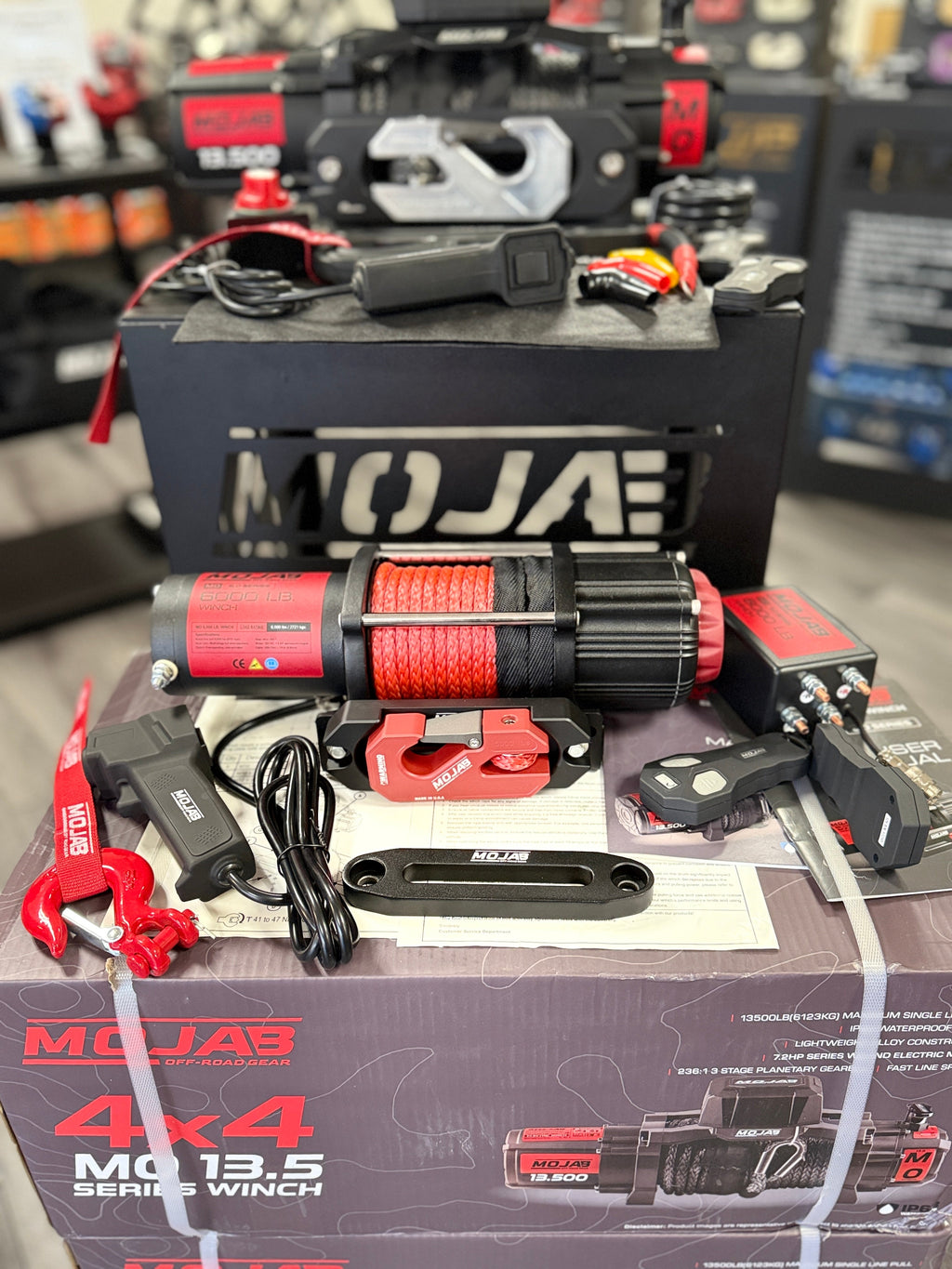 MOJAB OFFROAD MO6.0 Series electric winch with steel cable and control switch, designed for off-road vehicle recovery.
