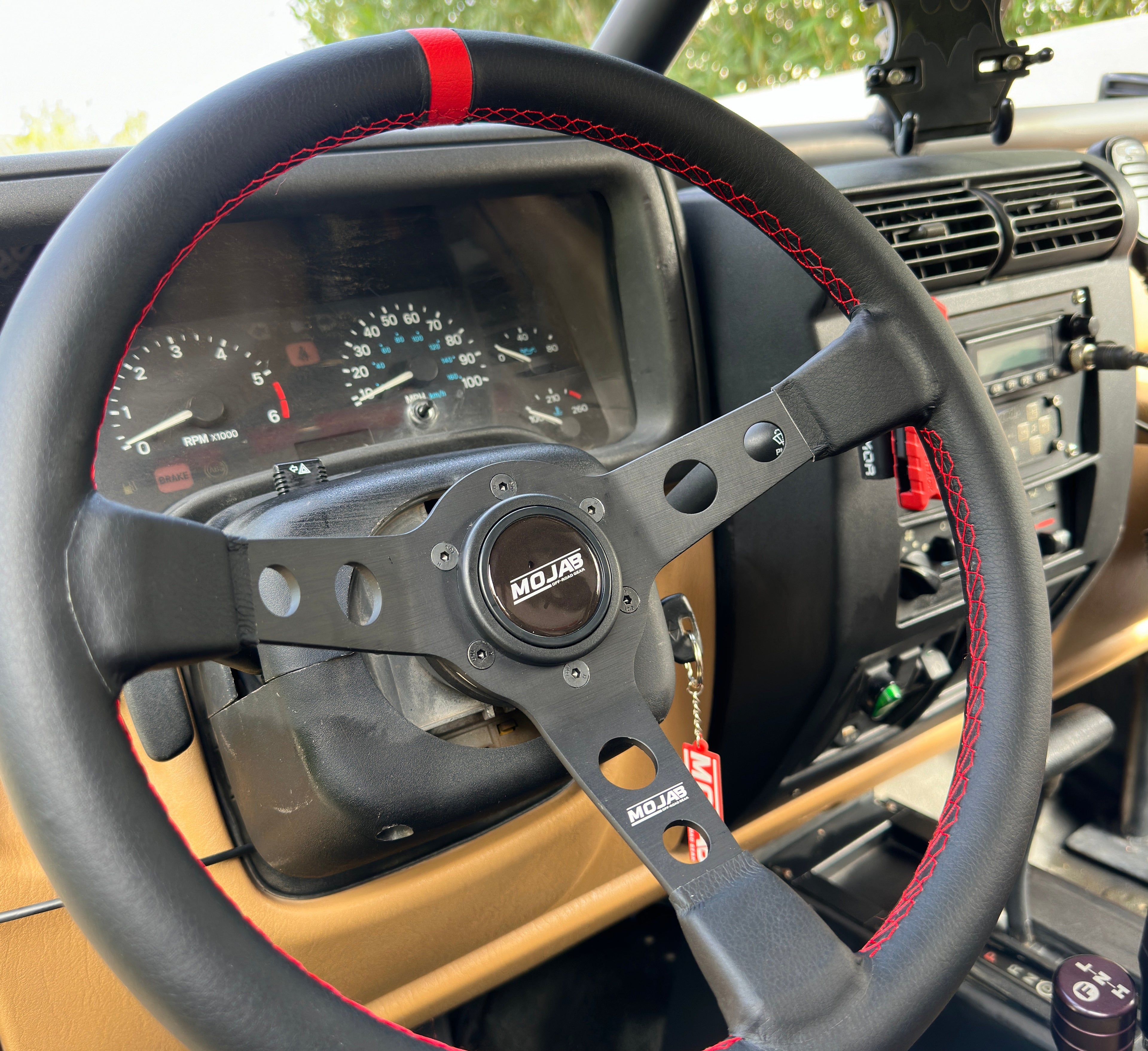 13.5-inch MOJAB OFFROAD deep dish steering wheel in premium leather or suede with ergonomic design.