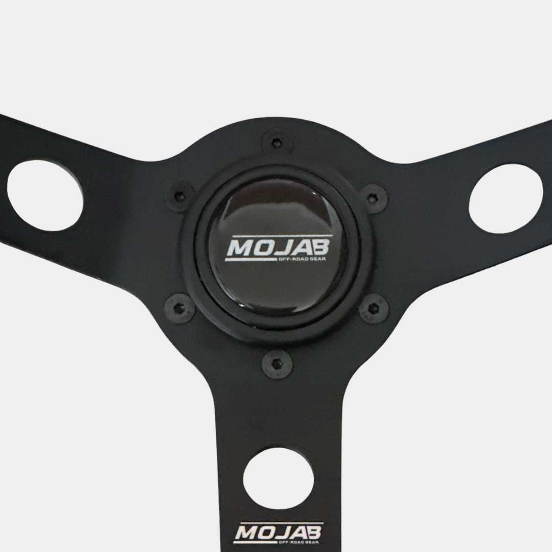13.5-inch MOJAB OFFROAD deep dish steering wheel in premium leather or suede, showcasing the textured grip and sleek design.