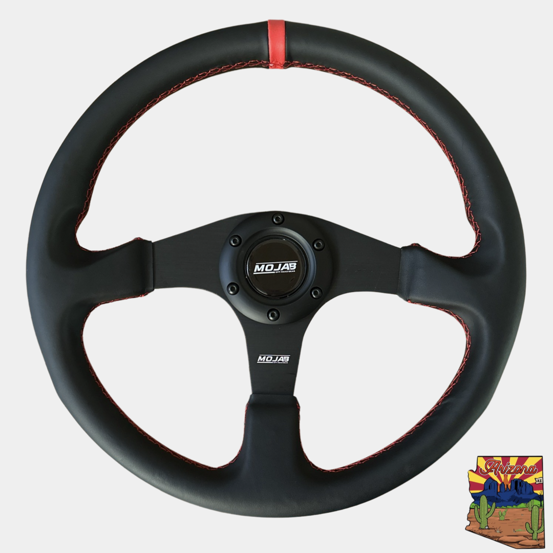 13.5-inch MOJAB OFFROAD flat steering wheel in leather or suede, showing a close-up of the textured grip and sleek design.