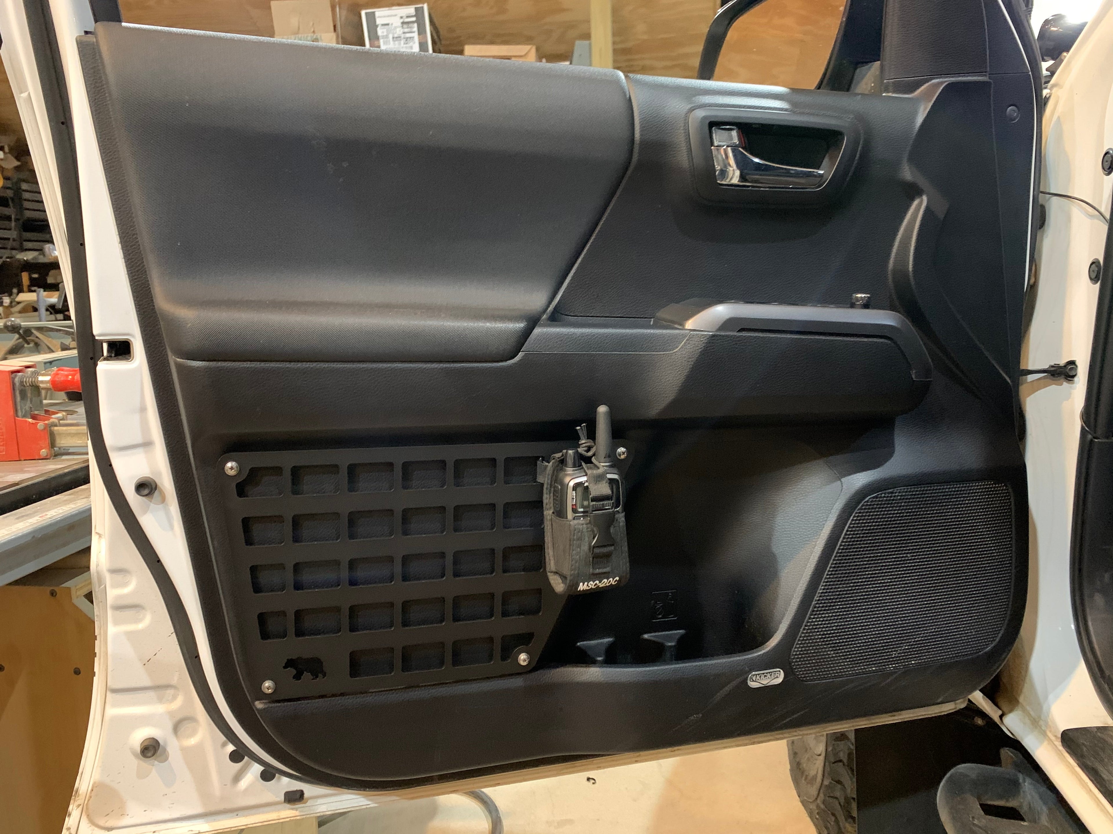 3rd Gen Tacoma door Molle panel set by New Holland Overland, black metal with multiple attachment points for gear storage.